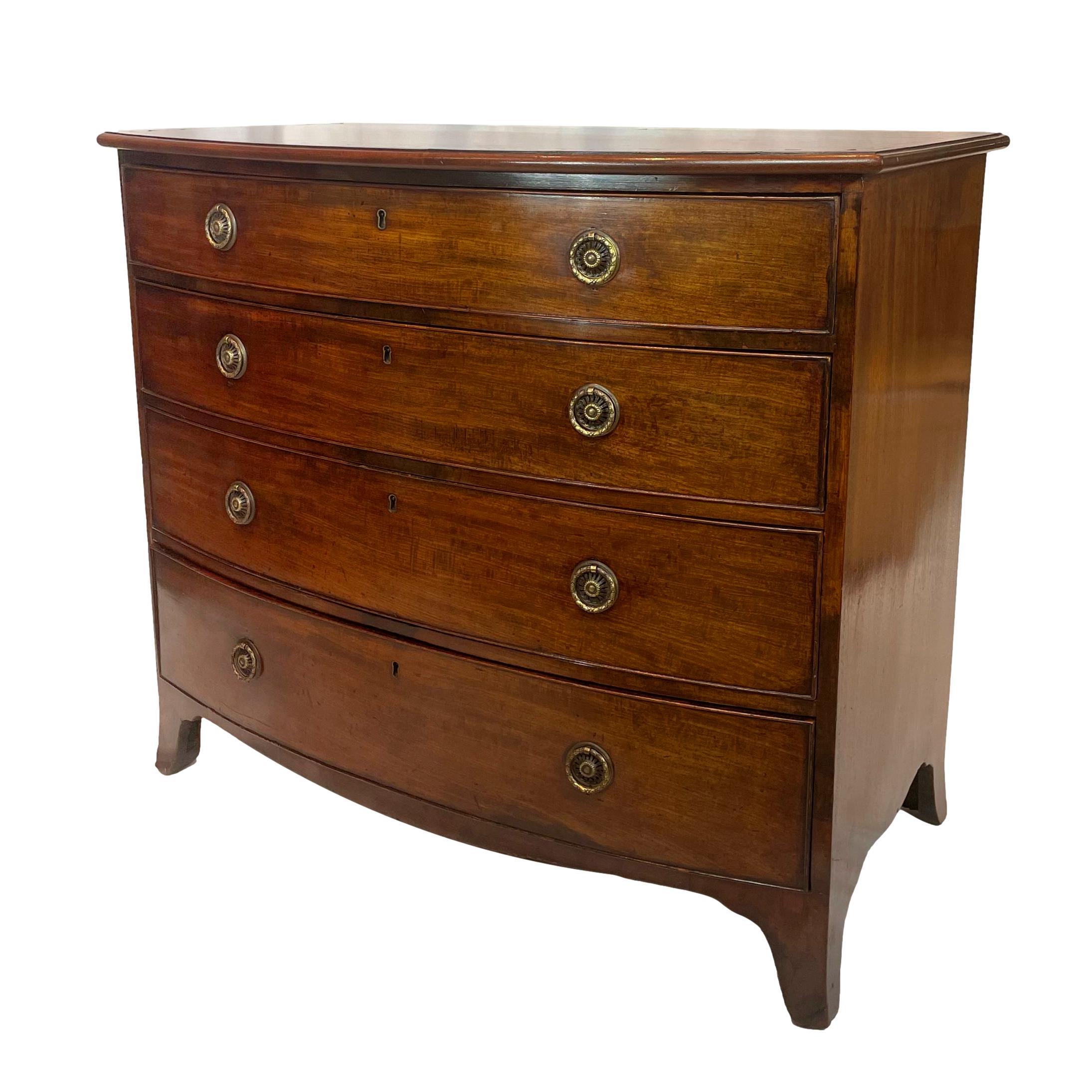 Georgian Mahogany Bowfront Chest-of-Drawers, with four long cock-beaded drawers above a shaped apron and splayed feet, the top with satinwood cross-banding and stringing, with highly detailed stamped and embossed brass rosette ring pulls, English,