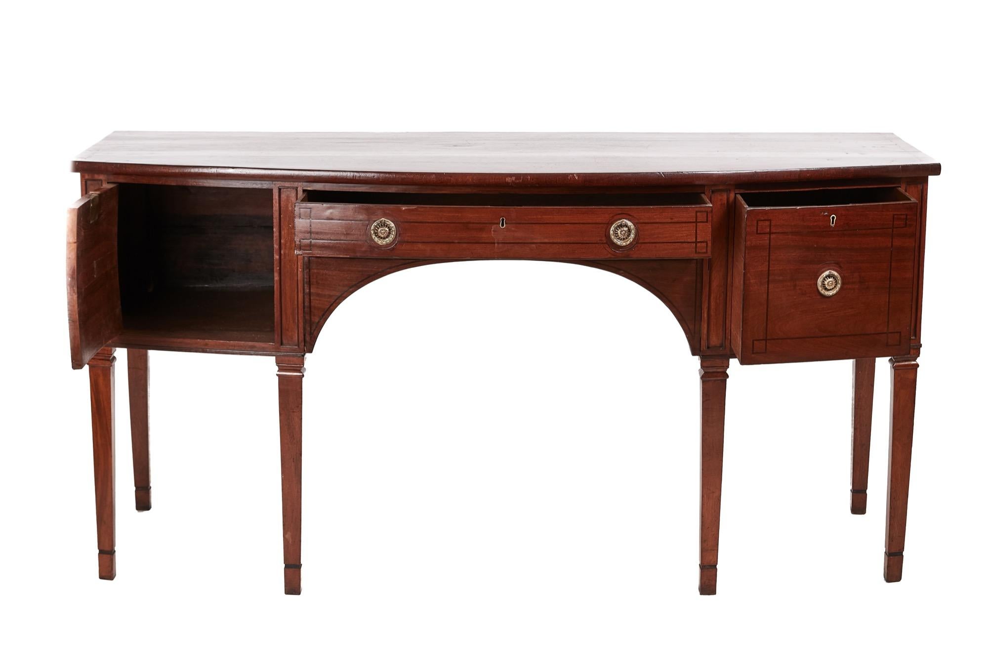 George III mahogany bowfront sideboard, the top with inlaid ebony stringing, fitted with a single centre drawer, flanked by a cupboard and a drawer, standing on six square tapering legs
Lovely color and condition
Measures: 72