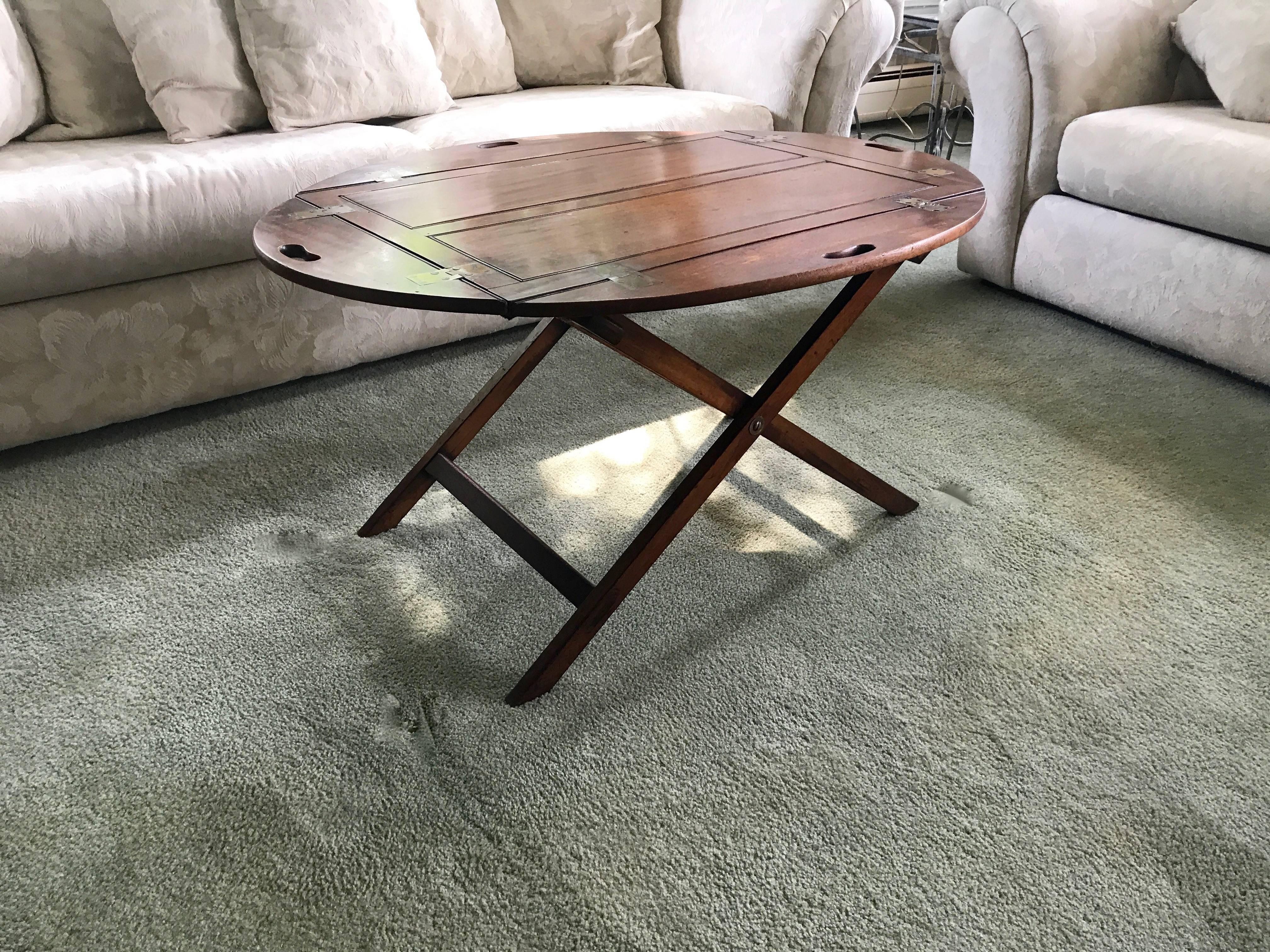 George III mahogany Butler’s tray, circa 1780. With original stand, brass hinges. Substitute the mundane coffee table and entertain your guests in style. This piece will be the talk of the room for certain! Felt was carefully added to the bottom to