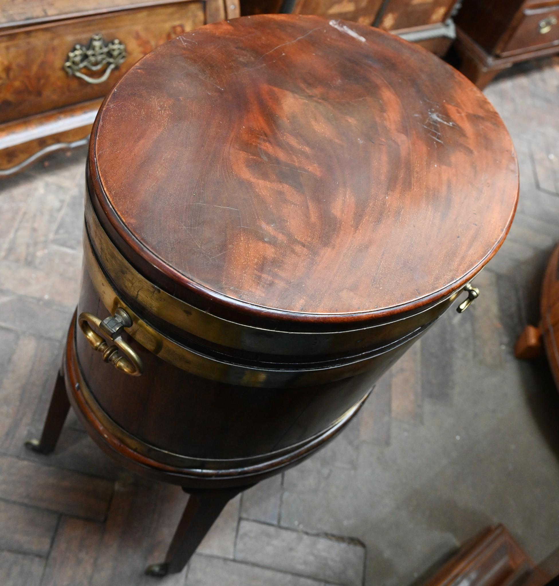 You are viewing a gorgeous period George III cellarette wine cooler
Circa 1770
Crafted from mahogany with triple banded brass decoration and handles
Stands on original castors so easy to move
Oval shape and a lovely patina to the mahogany
Lined with