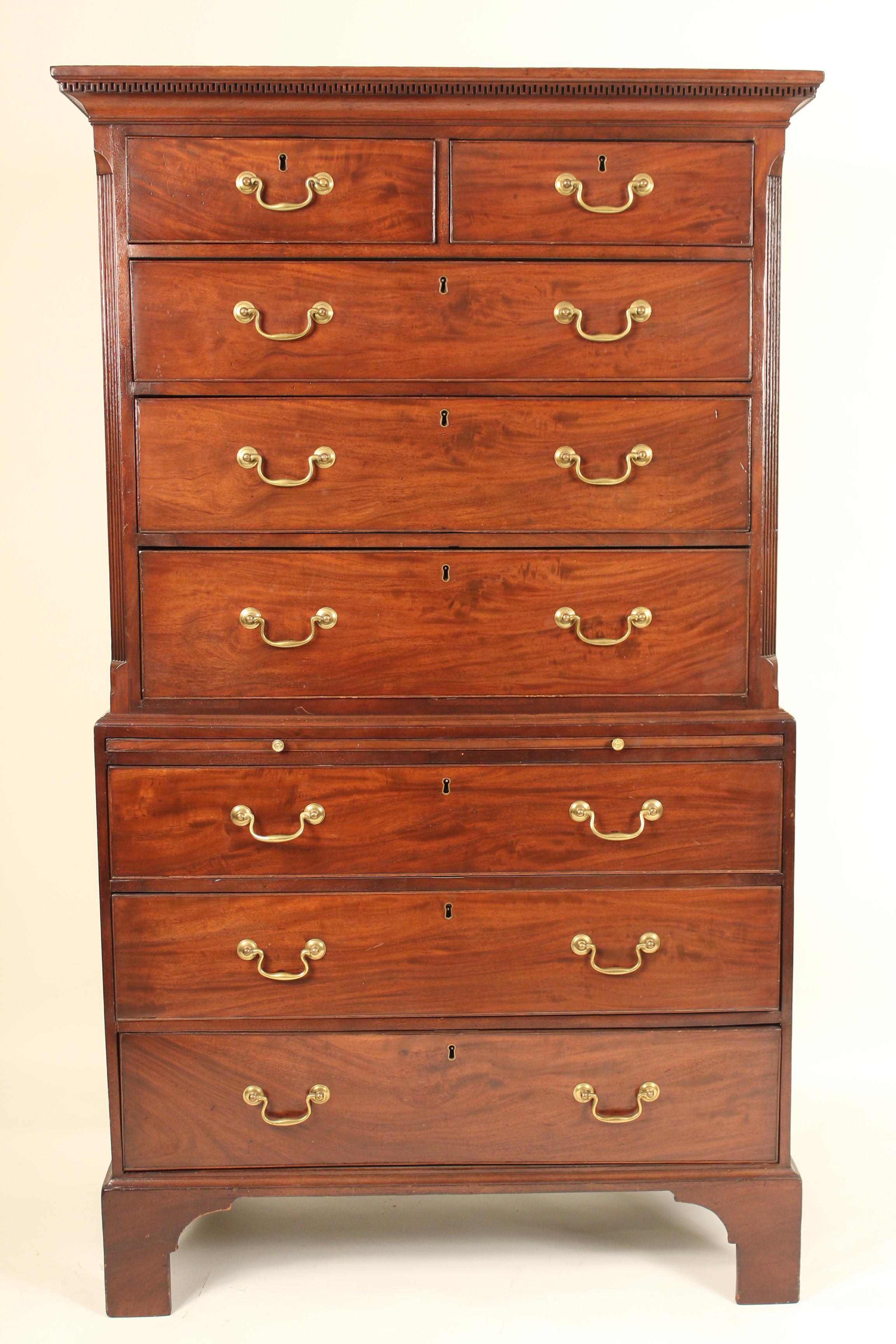 George III mahogany chest on chest, late 18th century. With nice lively mahogany used on the front drawers. The top section with dental molding on the pediment and canted corners with fluted columns. The bottom section with a pull out felt lined