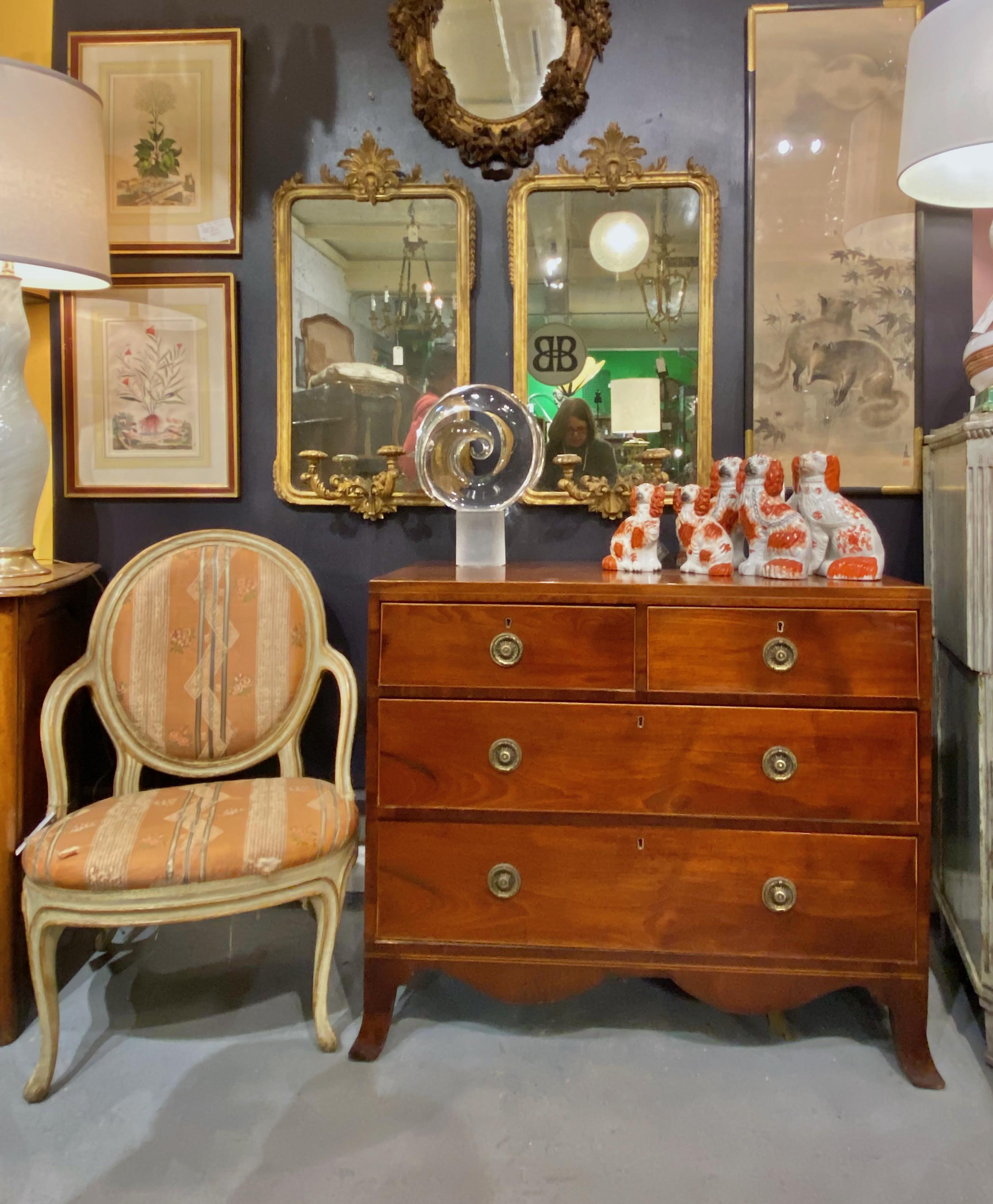 This is a classic George III mahogany with satinwood banding chest of drawers with a two-over-two configuration. The perfect and elegant proportions of the chest make this this piece an eye-catcher. The surface has been French polished, but it