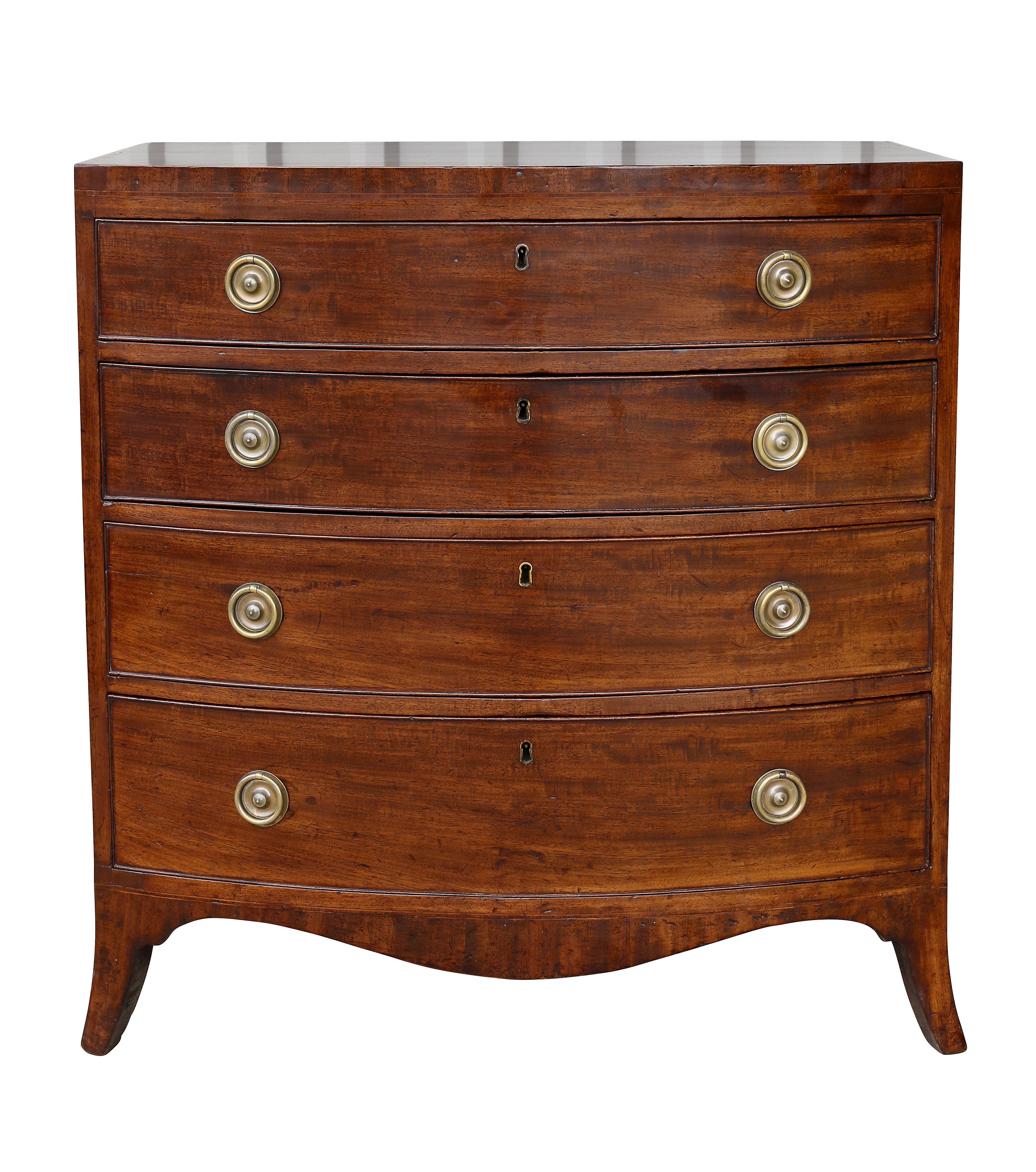 With a bowed top over four graduated drawers with circular brass ring handles raised on splayed legs.