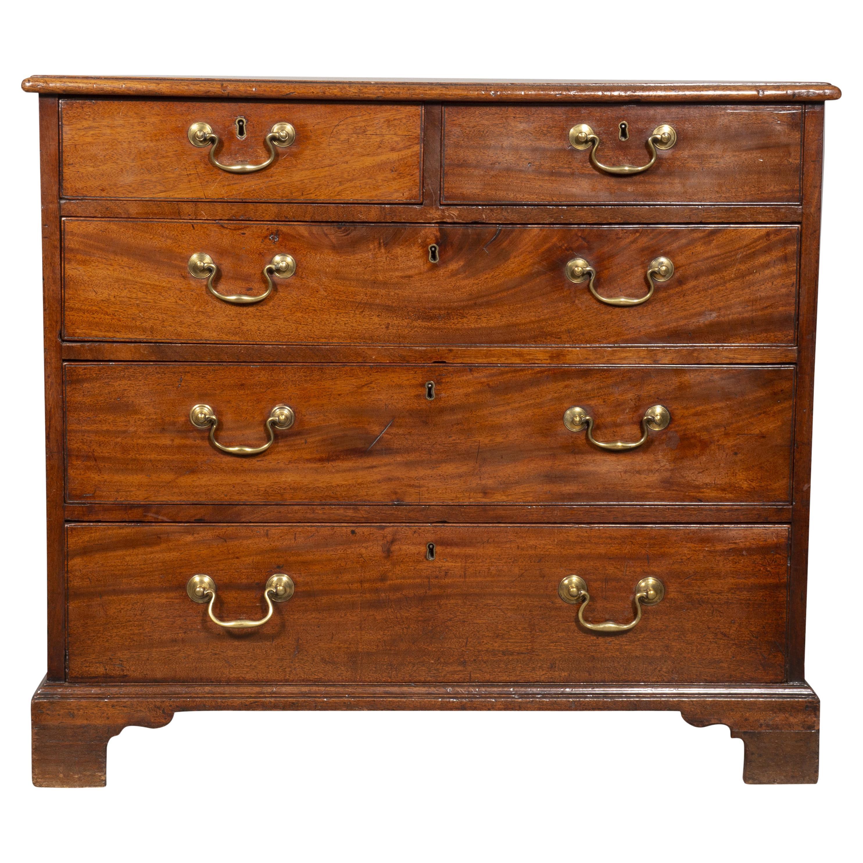 Made of fine quality of timber with rich brown color. Rectangular top with molded edge over two small and three long drawers with original brass bail handles, bracket feet. From the estate of Douglas S. Cramer, a famous television producer.