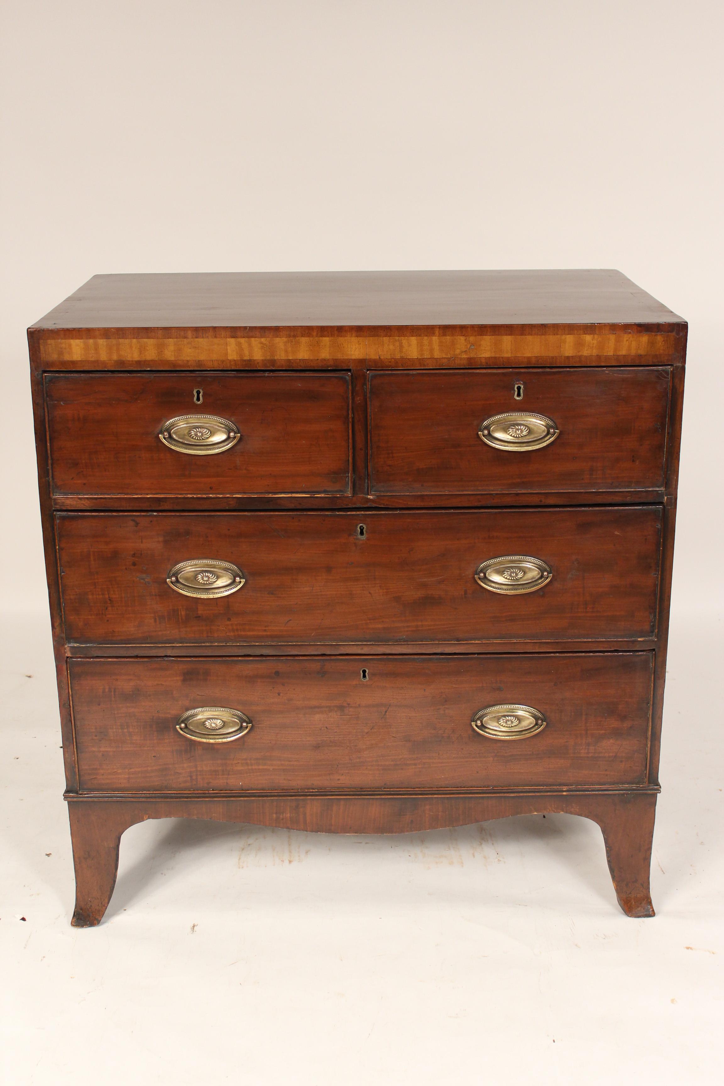 George III mahogany chest of drawers with a satin wood frieze, circa 1800.