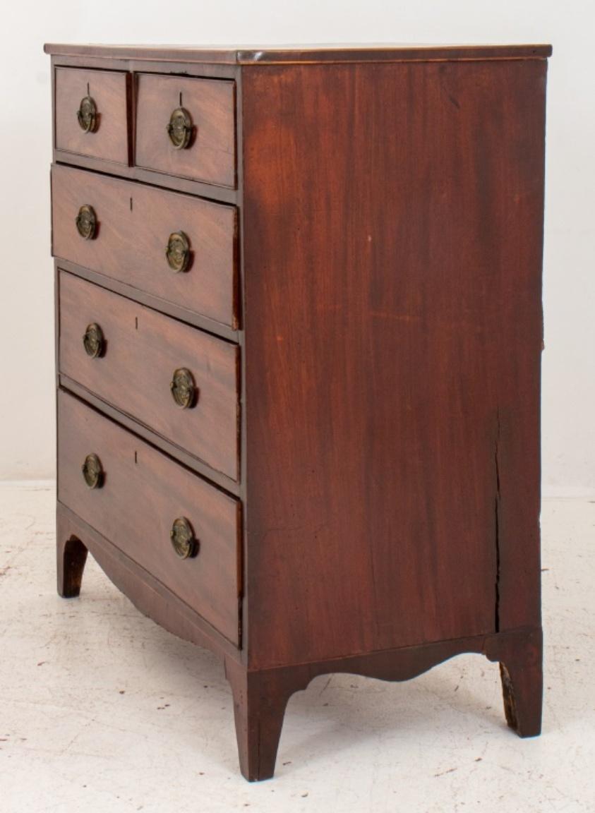 George III Mahogany chest of drawers, circa 1800, of rectangular form, with two short over three long drawers, with shaped feet. Some warping and cracks and consistent with age and use. Overall in good antique condition. 

Dimensions: 40.5