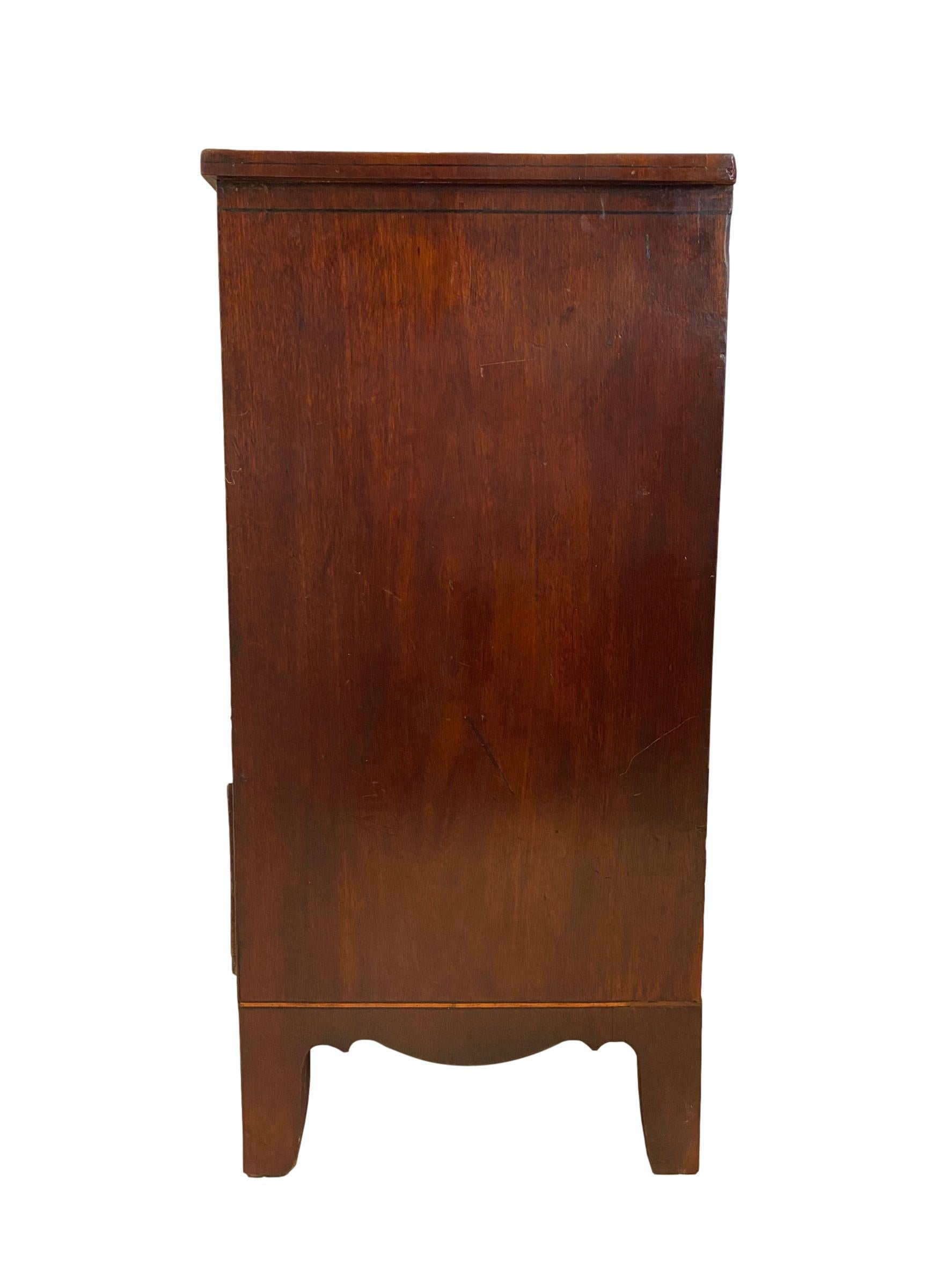 George III (Regency) mahogany chest-of-drawers, three short drawers over three long drawers, with a shaped apron, on saber legs, English, circa 1820.