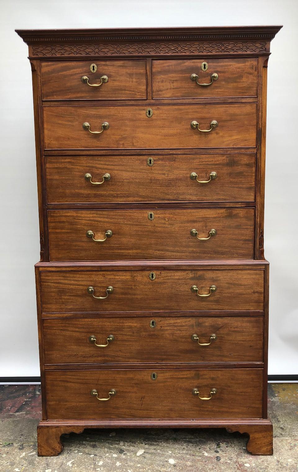 This Georgian Chest on Chest has a refined carved blind fretwork frieze with dentil molded cornice. The Chippendale Chest-on-Chest is of a Classic British Design with canted corners with Lambs Tongue and blind fretwork carving. The top chest has an