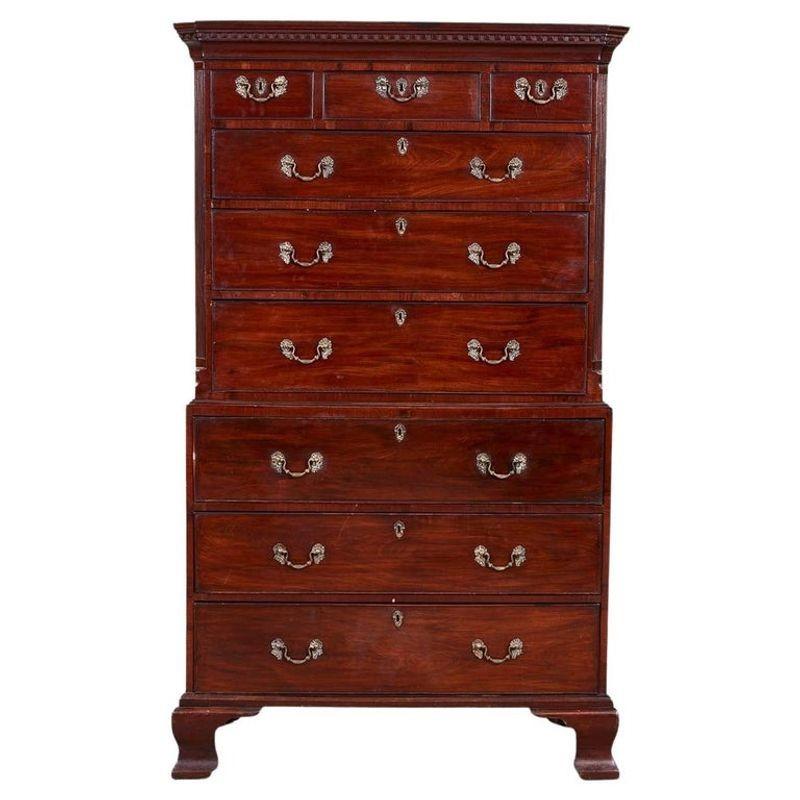 Fine Georgian period mahogany chest on chest, the dentil molded top with reeded canted corners having three short and three wide drawers over lower section having secretary drawer and two lower drawers and standing on high ogee bracket feet, the