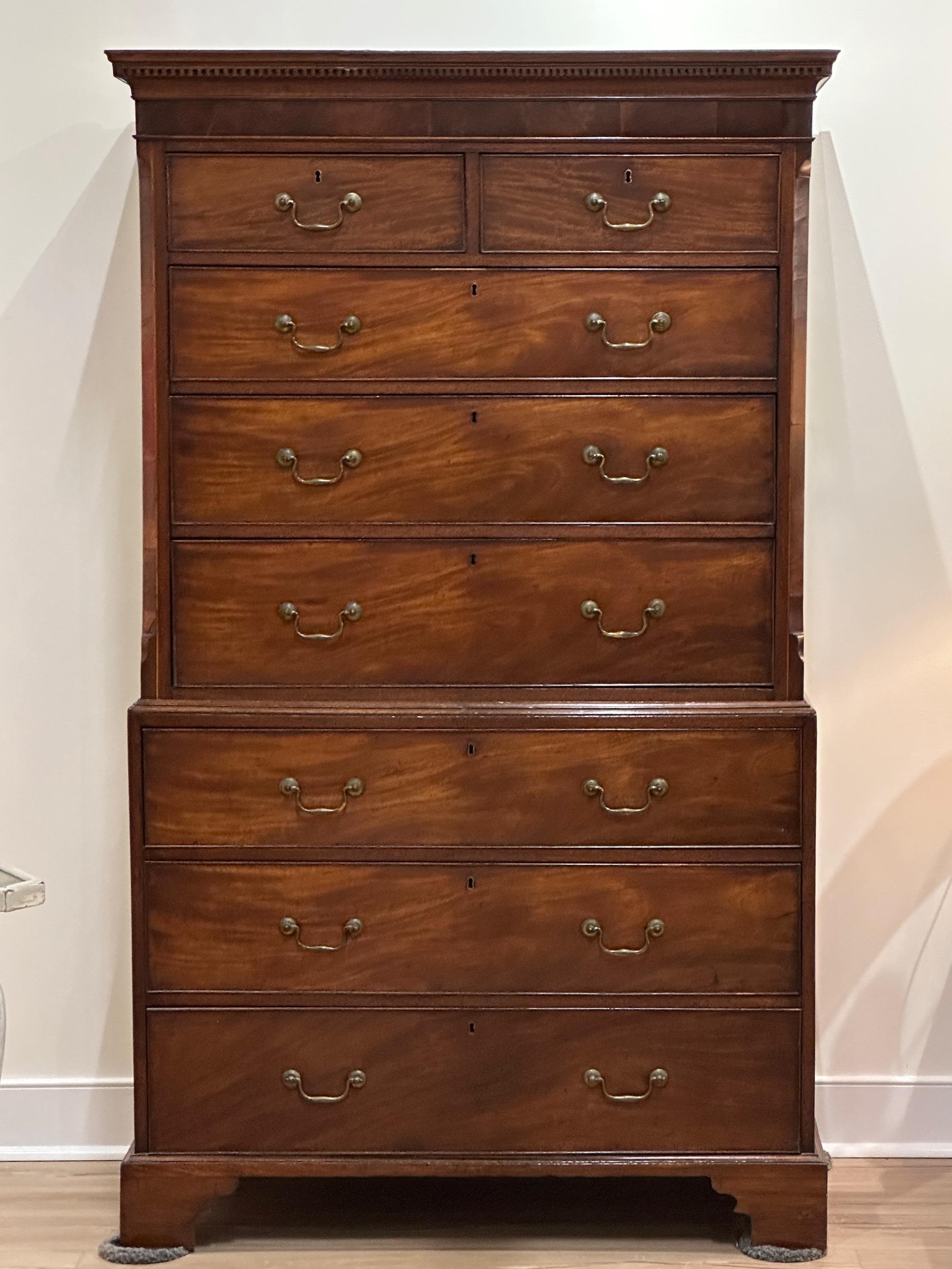 A handsome late 18th C English George III mahogany chest on chest. The upper portion contains two top drawers and three graduated drawers beneath, the lower with three graduated drawers all with original brass pulls on carved bracket feet.