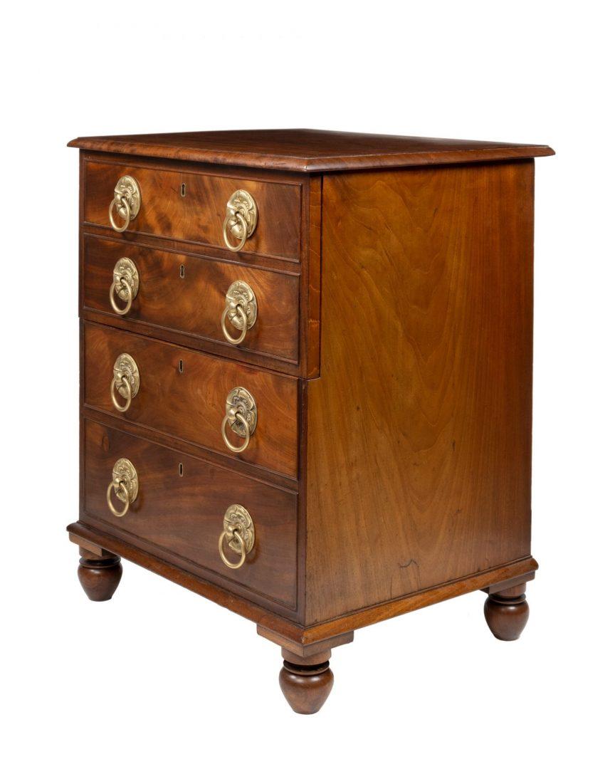 A George III mahogany commode attributed to Gillows, modelled as four drawers with brass drop handles with circular backplates and raised on short turned feet, this has been skillfully altered to become a cellaret, the old interior has been removed