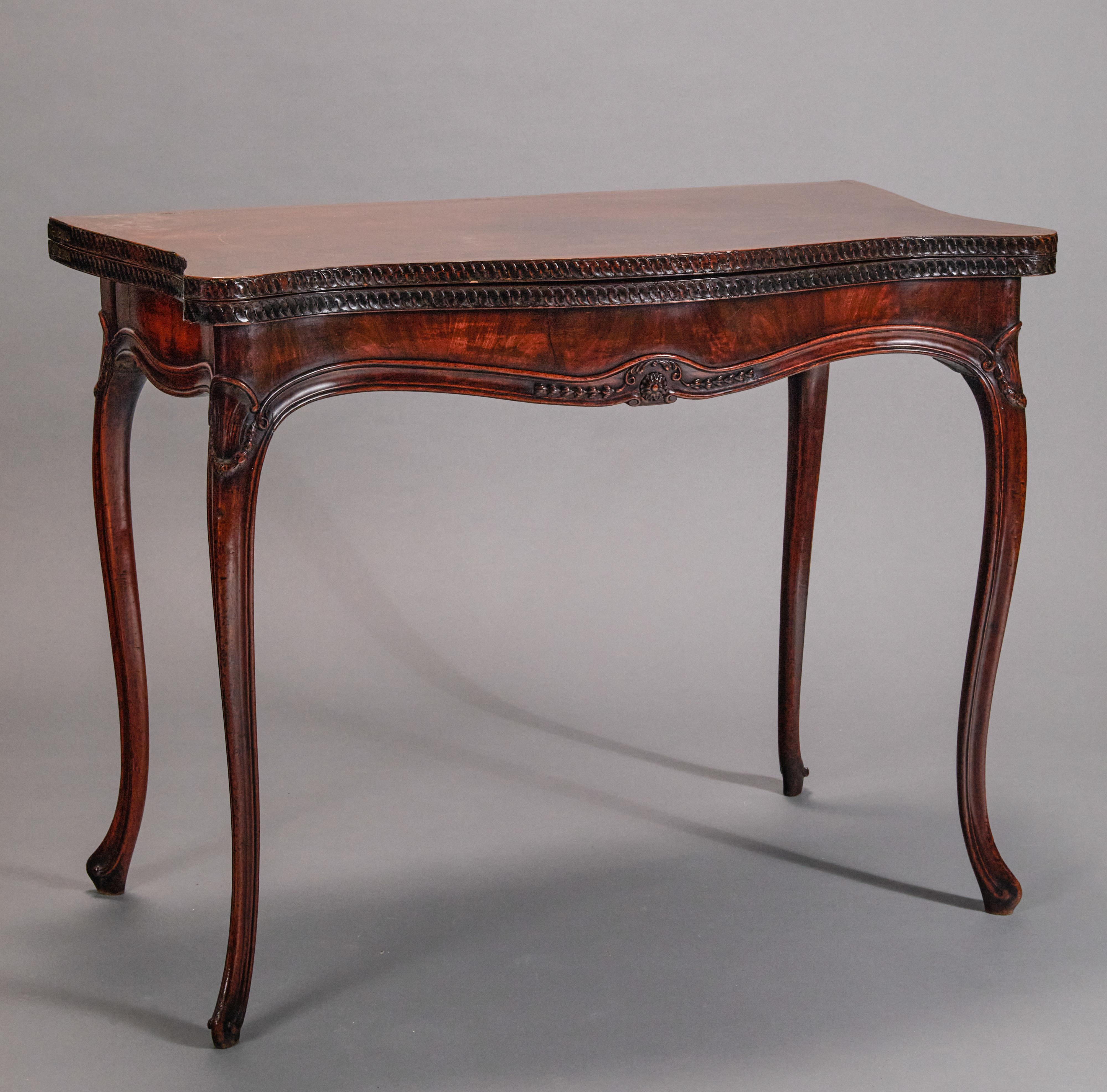Rectangular, marquetry banded, fold-over top enclosing a leather playing surface with gold trim design. In french taste after a design by George Hepplewhite. When hinged top is open it measures 35 1/4