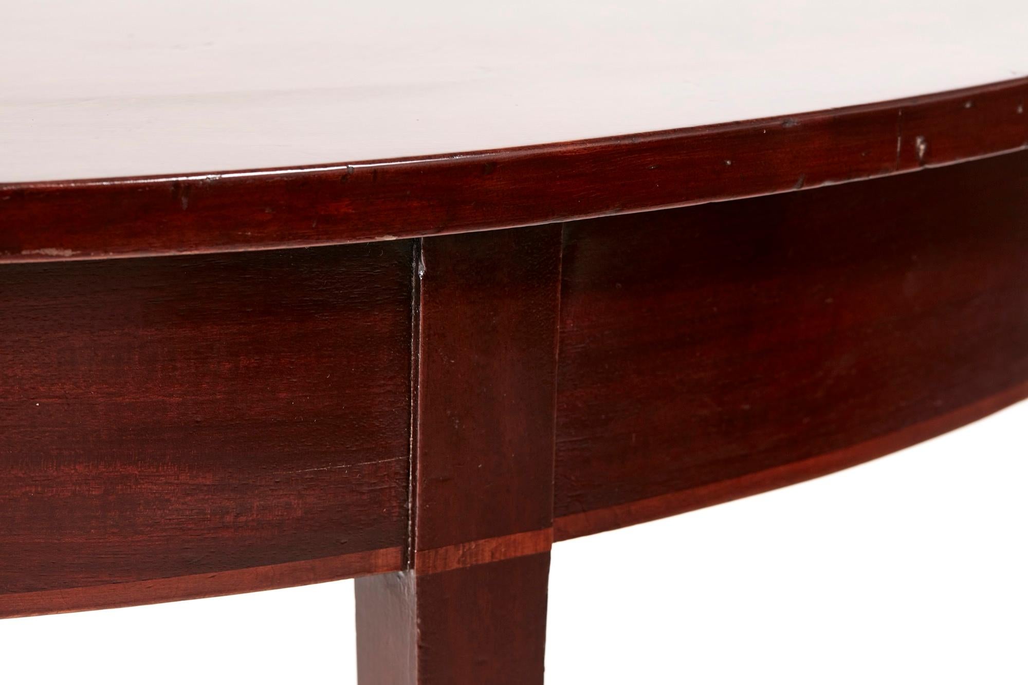 Antique George III mahogany demi lune console table with an attractive and quality solid mahogany top, shaped frieze with satinwood inlay, standing on four square tapering legs

A quality example with a desirable colour and patina.

  