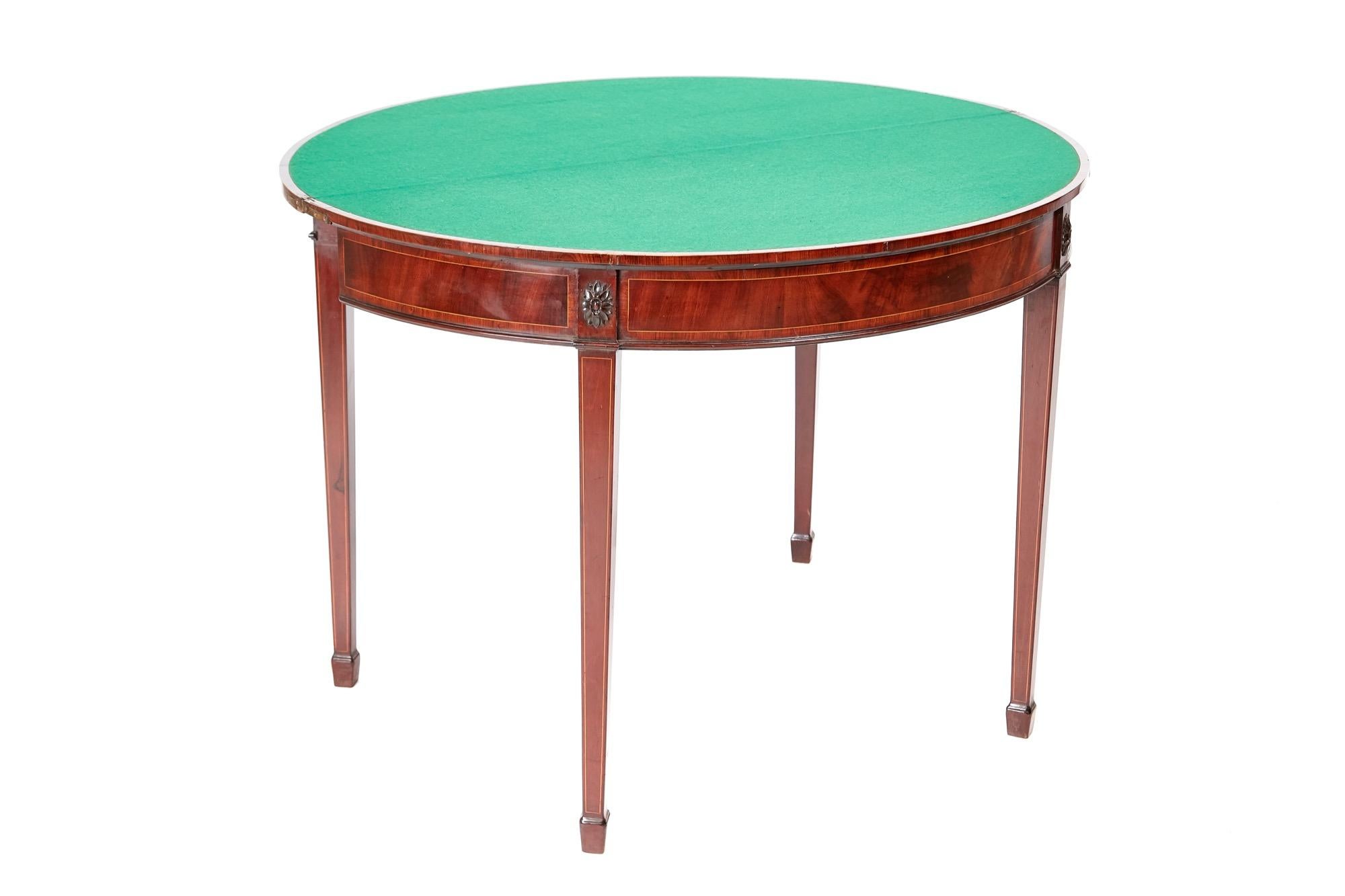 George III Mahogany demilune card table, having a lovely mahogany top crossbanded in satinwood, green baize interior, mahogany frieze crossbanded in satinwood, standing on four inlaid square tapering legs with spade feet,
Lovely color and