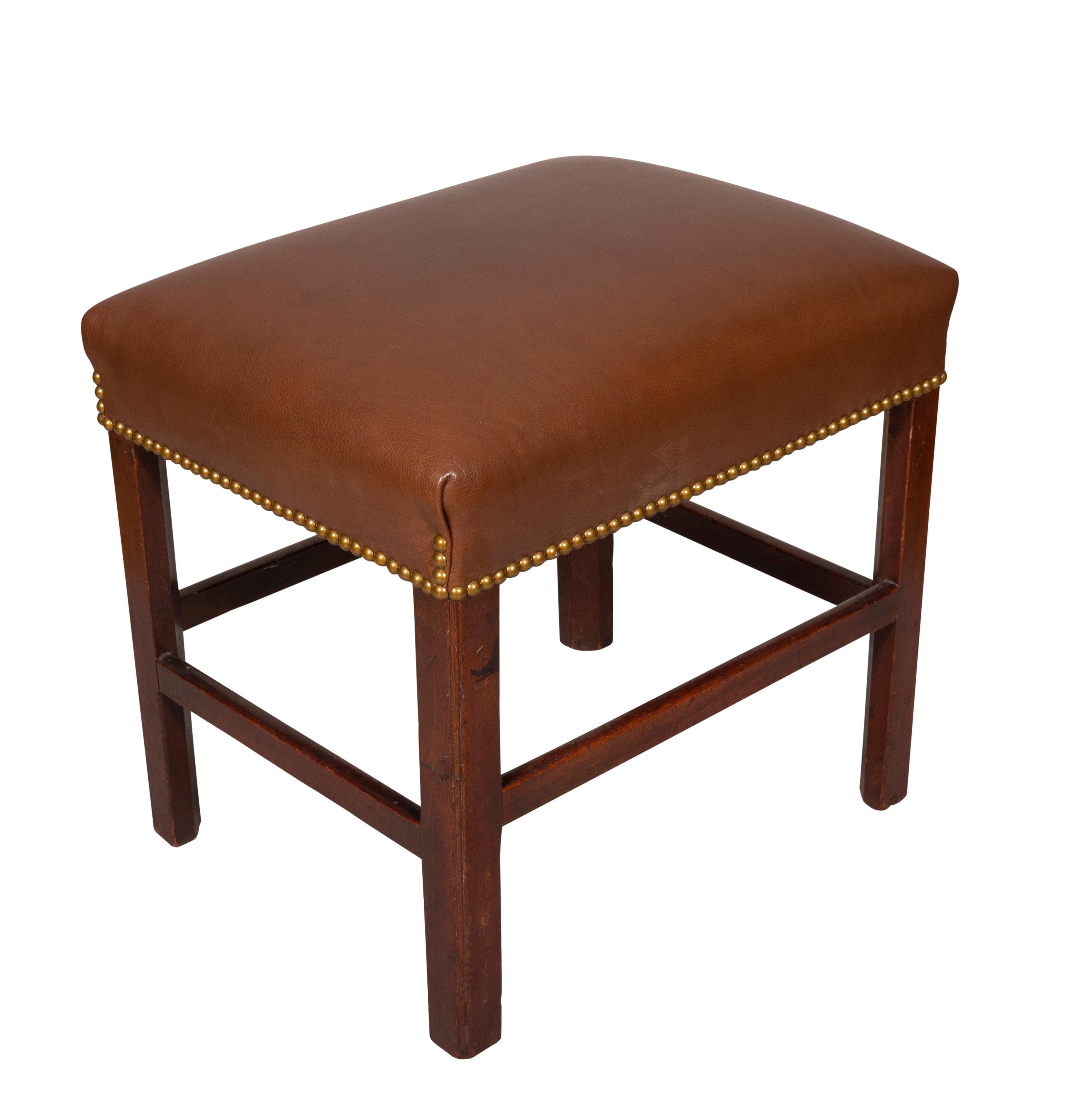 Rectangular brown leather top with brass tacking, raised on square section legs with box form stretcher. Estate of Douglas S Kramer. TV producer and art collector.