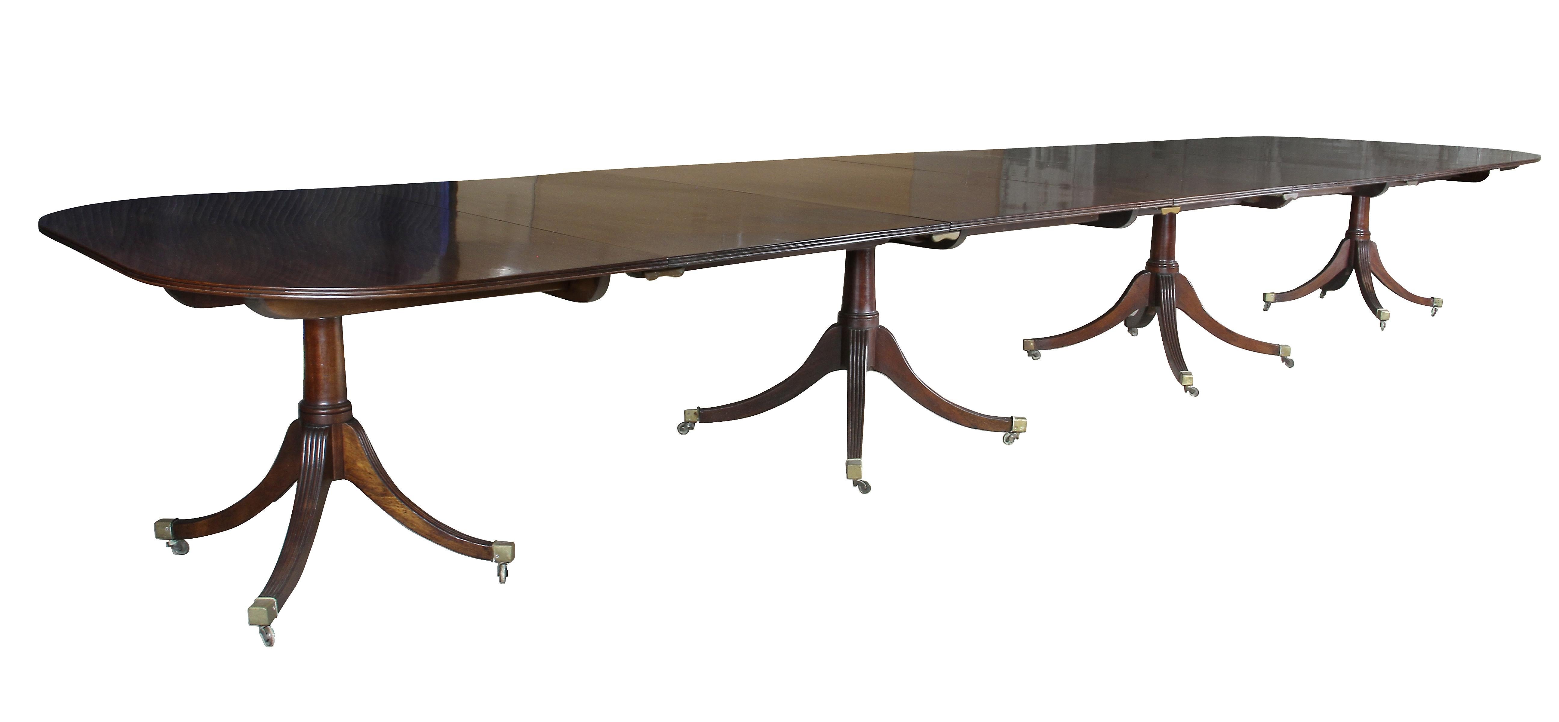 With a reeded edge and rectangular top of very generous proportions, each section with tilting mechanism, the four sections each raised on four turned supports each with four reeded splayed legs with square caps and casters. Additional edge leaves