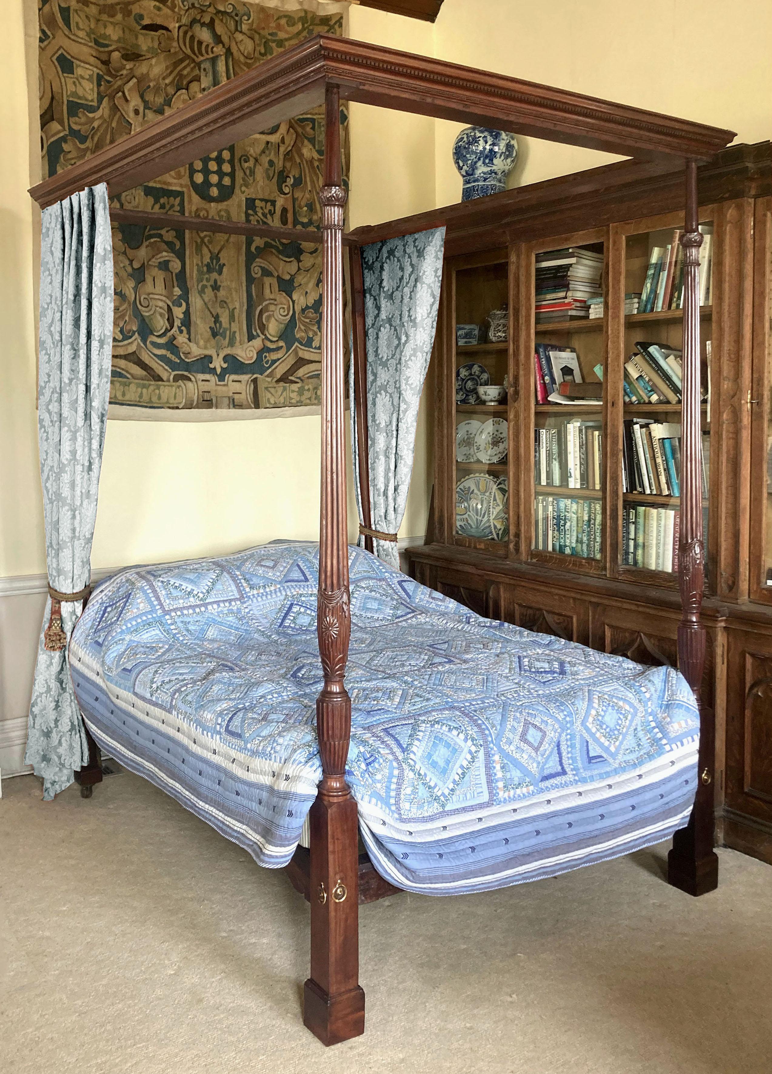 George III mahogany four-poster bed
A George III four poster bed with mahogany end posts particularly finely carved with acanthus leaves, drapery, rope twists, a complete daisy and extensive stop-fluted and reeded detail. The 19th cornice in the