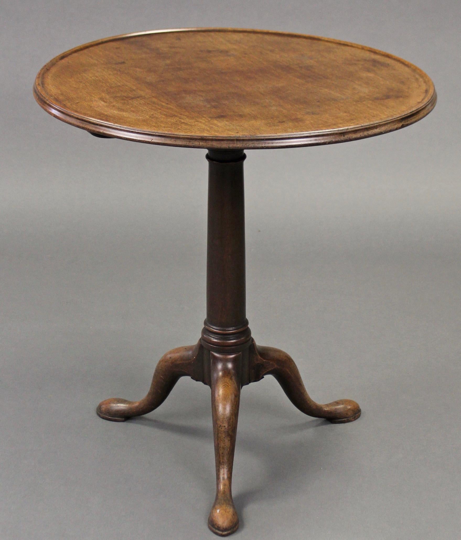 sA late 18th century Chippendale period George III mahogany tray topped tripod table, or as also known 'snap top table', circa 1770-1790, England. 

The circular tray top with moulded edge is raised on a gun-barrel centre column and cabriole legs