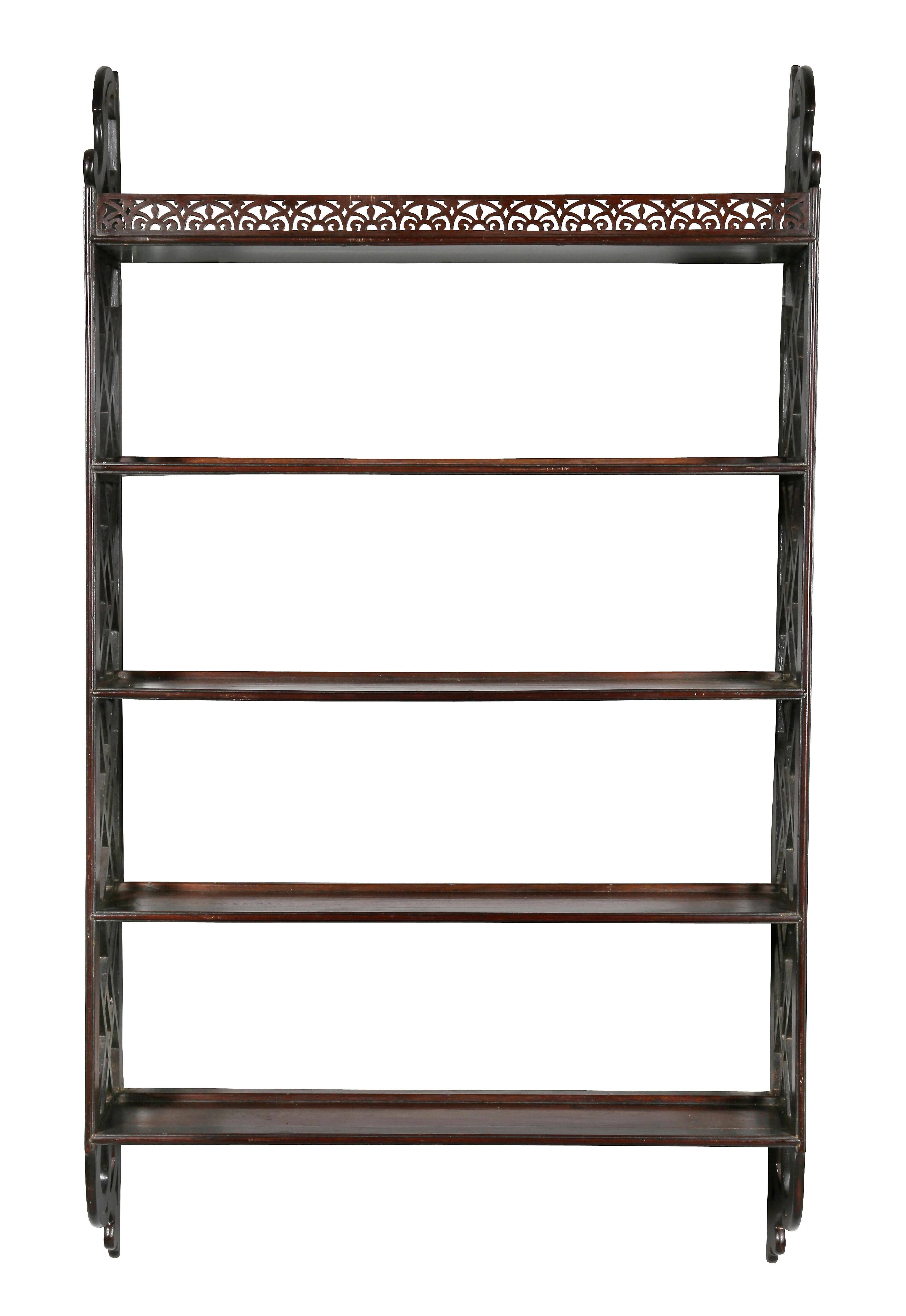 Four shelves over a fret carved gallery, sides with Chinese style open trellis work, scrolled volutes brackets top and bottom.