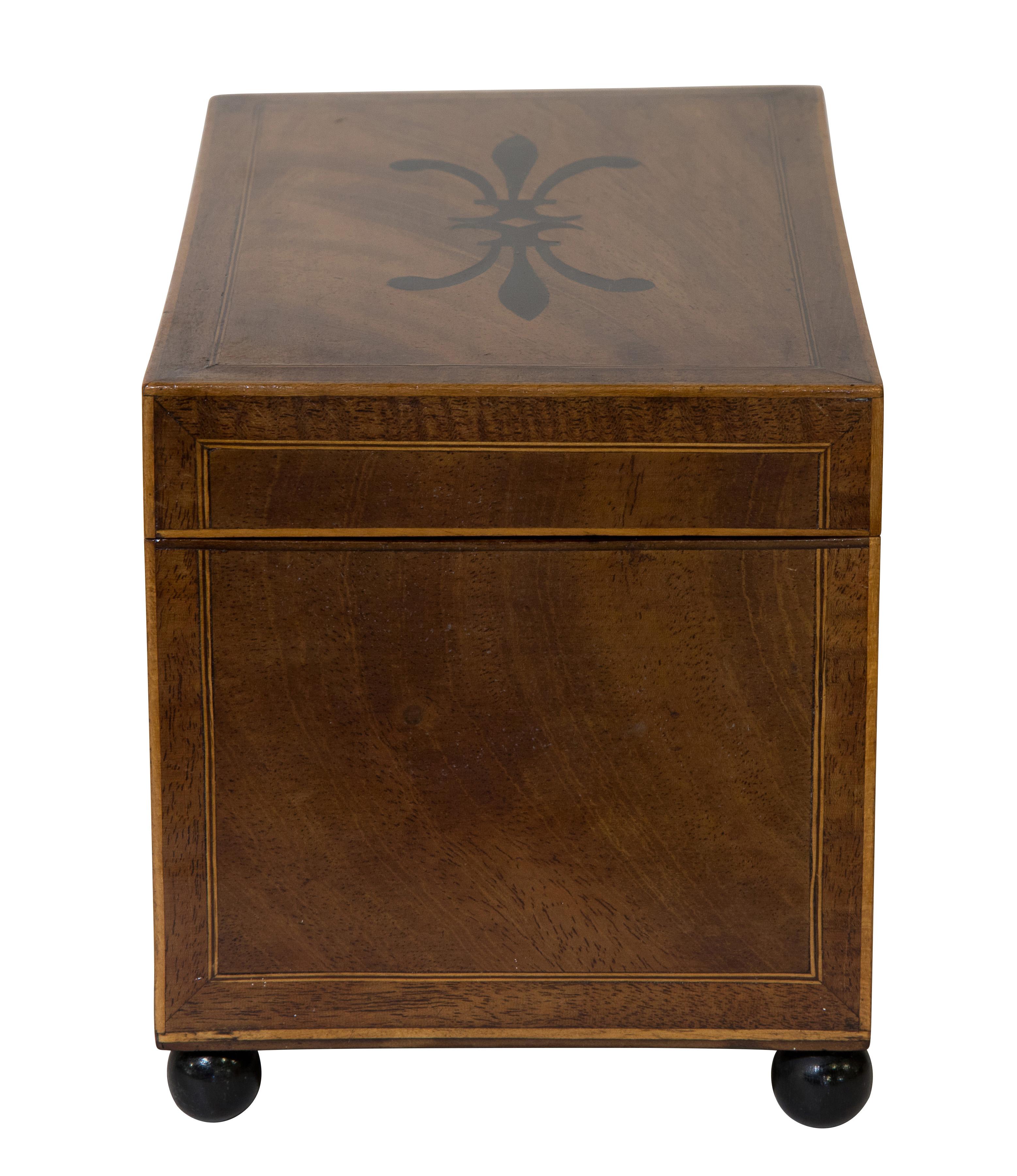 George III mahogany inlaid tea caddy on bun feet. (Provenance - from the estate of the late Lady Dodds).
