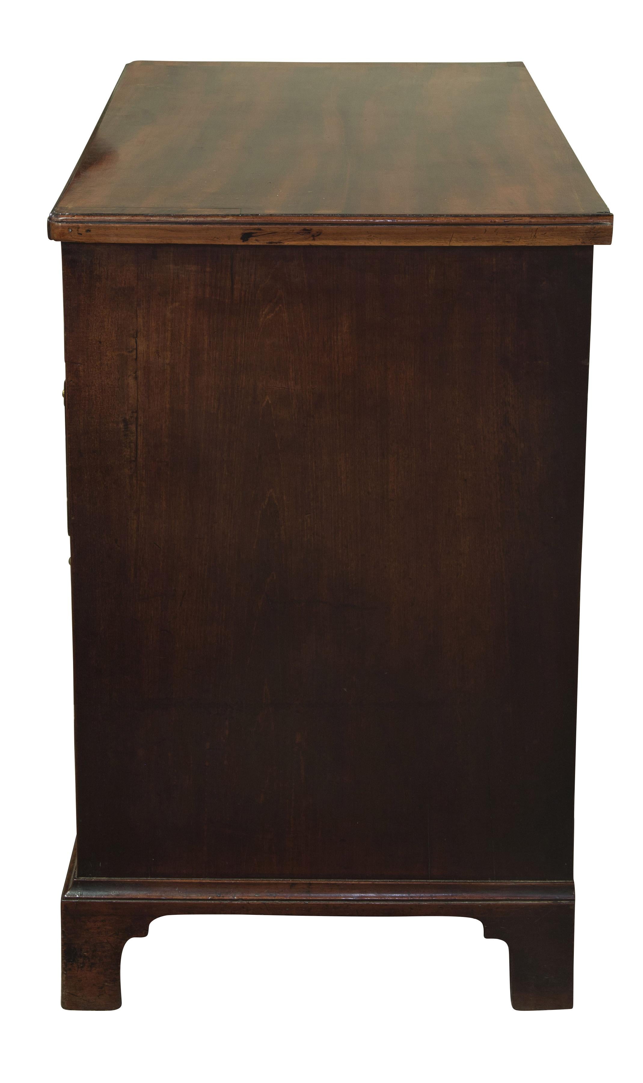 George III mahogany kneehold desk, with seven drawers and removable cupboard on bracket feet.