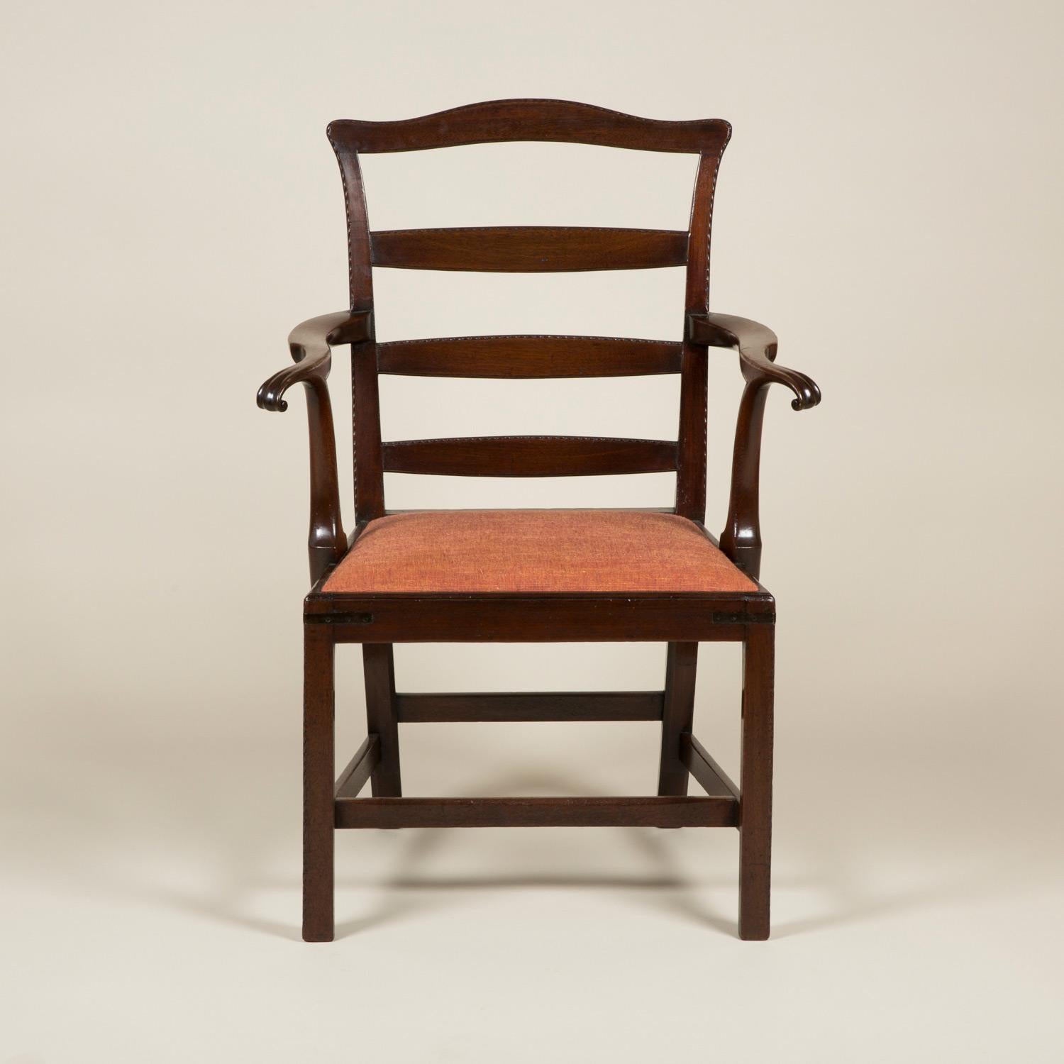 A George III mahogany ladder-back elbow chair with rope twist edges to the back and out-turned arms.