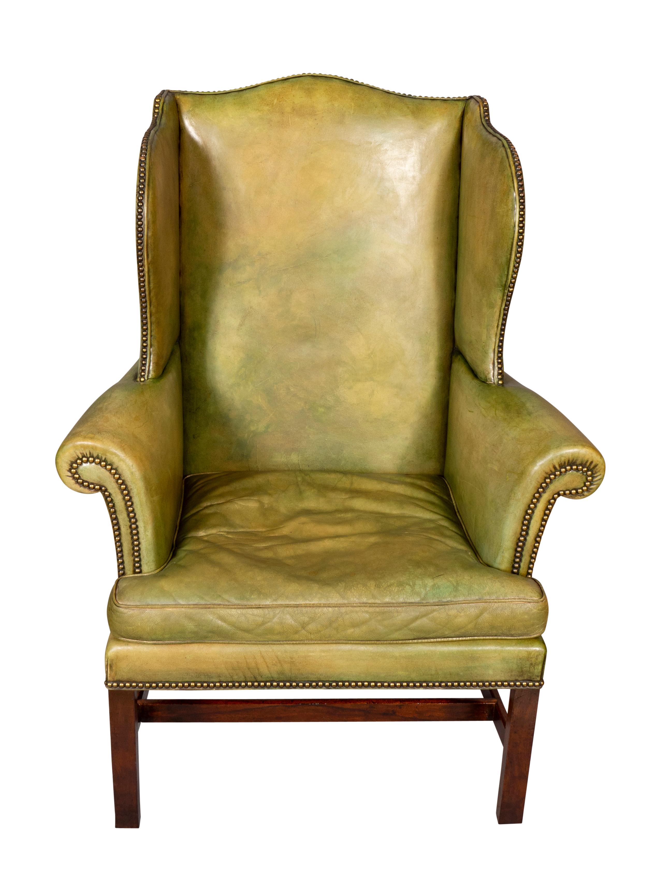 With green leather upholstery and brass tacks, nice proportions with square section legs and H form stretchers.