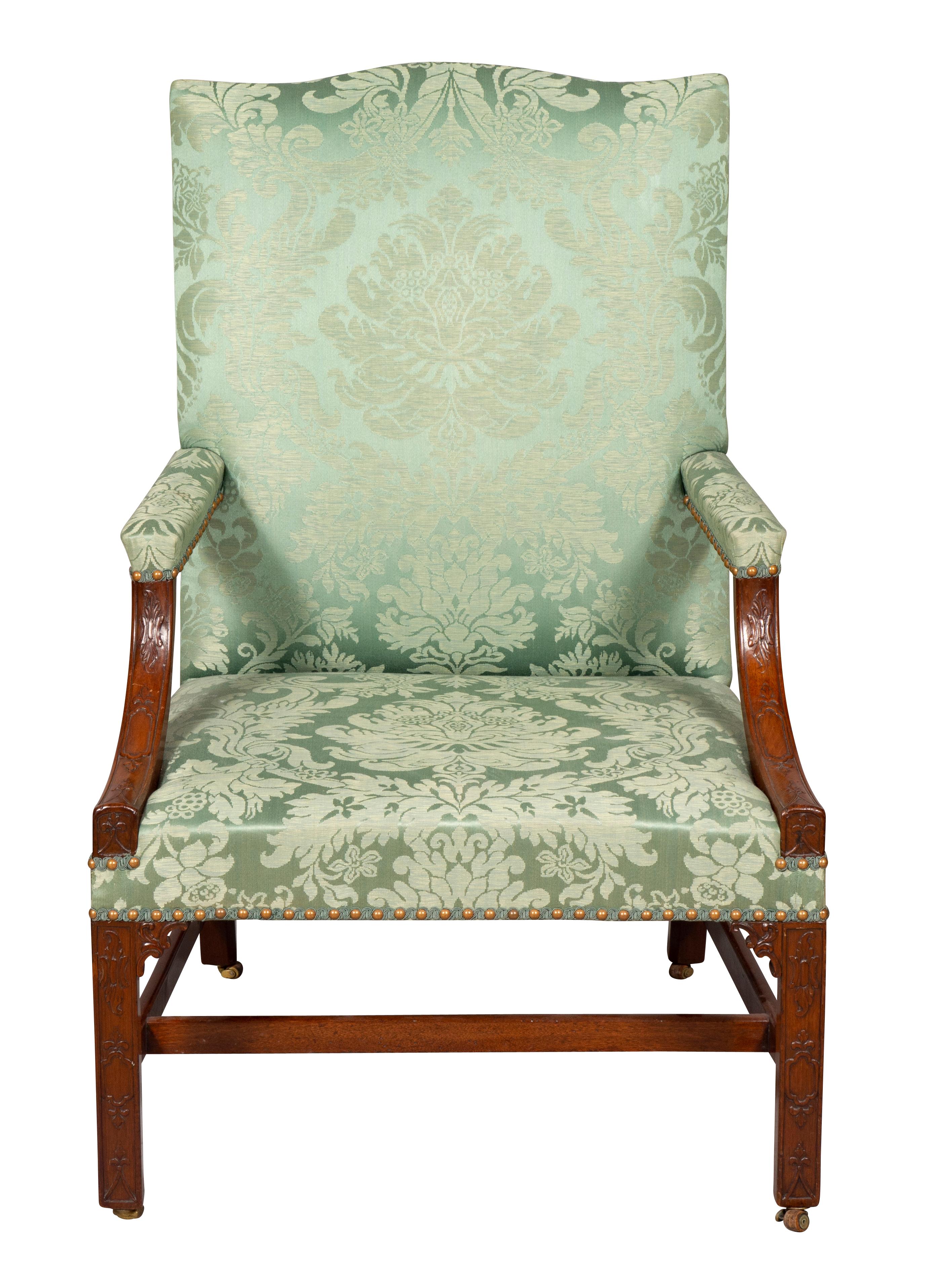 Serpentine crestrail and green damask upholstered back and seat with brass tacks, fret carved curved arms, raised on fret carved Marlborough legs headed by carved spandrels. casters. Fabric in very good condition.