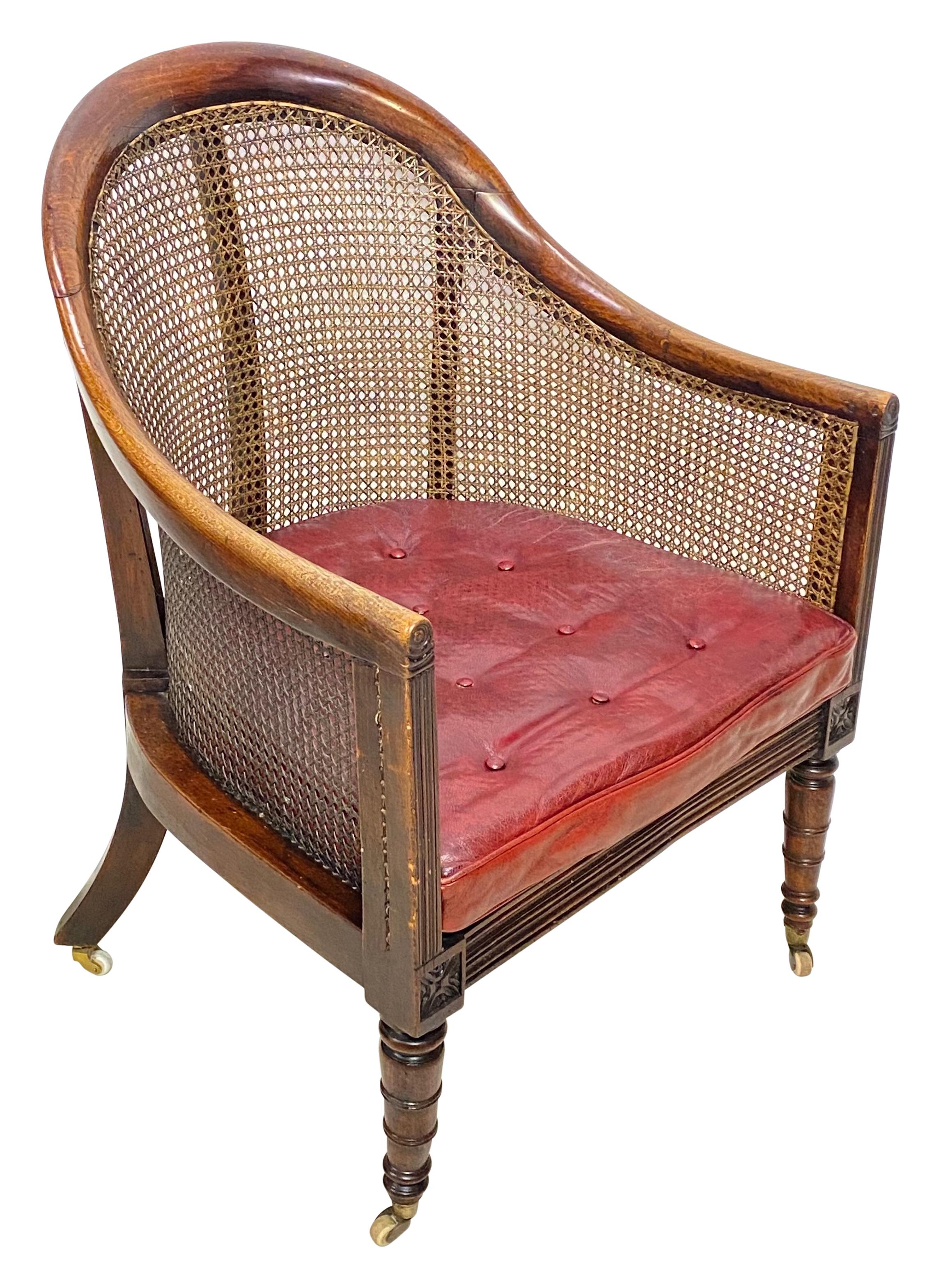 An early 19th century George III mahogany library chair in exceptional condition with original finish and patina. All caning is in perfect condition, Cordovan leather cushion has original horsehair stuffing (cushion has leather on both