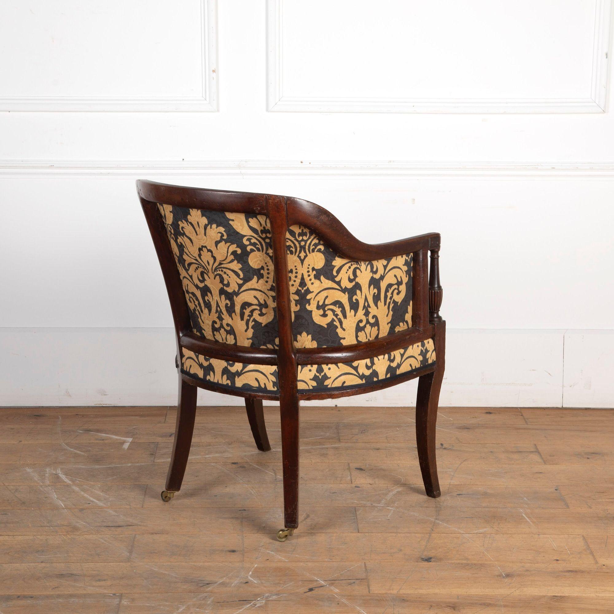 Fine early 19th Century Geo III mahogany upholstered library chair.
The arched back sweeps down to form armrests, with fluted baluster armrest supports to the front supported on square legs.
English, circa 1810.