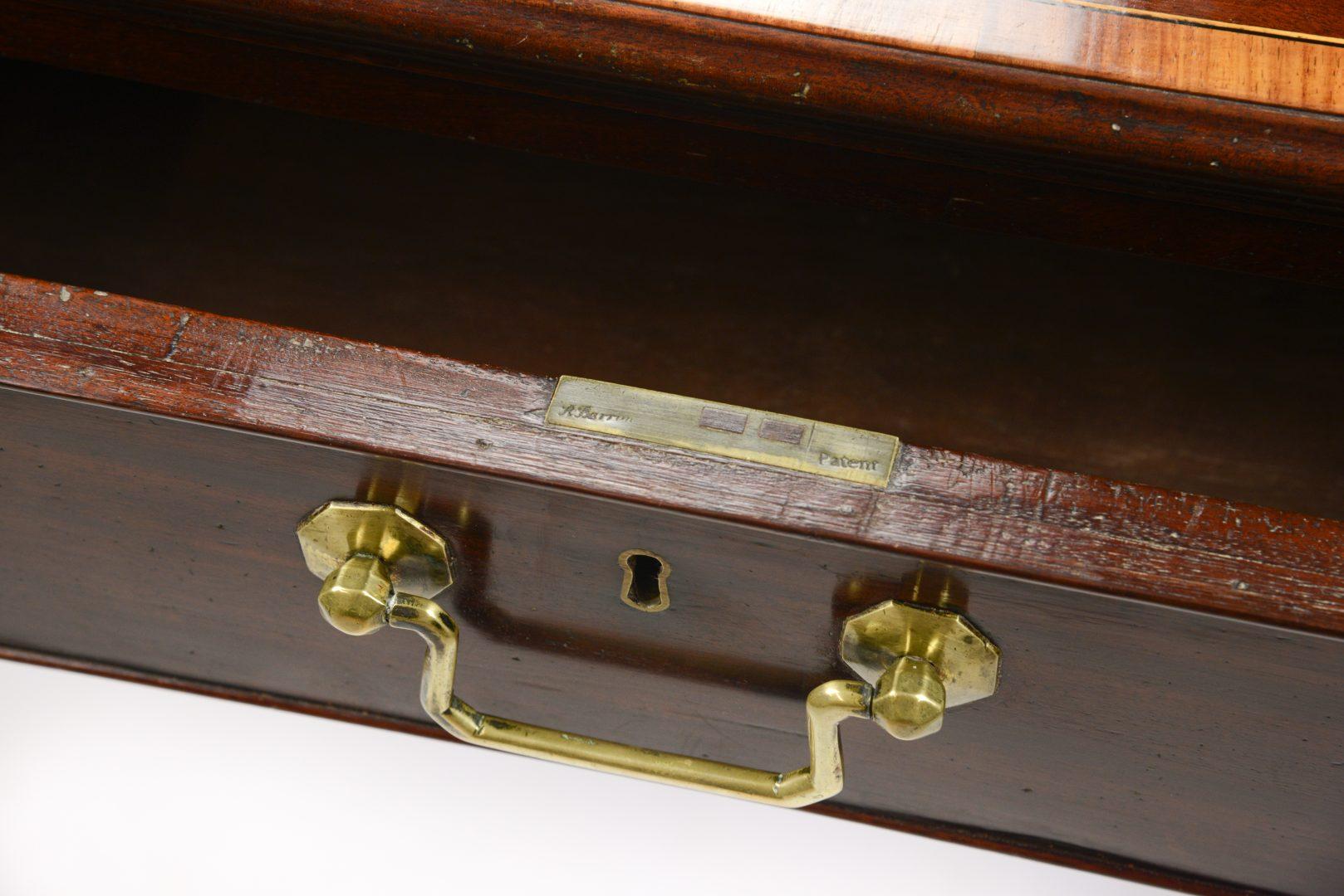 A George III plumb pudding mahogany library table, 1770-1780 the top cross-banded in tulipwood and line inlaid, all four sides fitted with drawers or blind drawers, original locks and handles.

The library table has draws on two opposing sides so