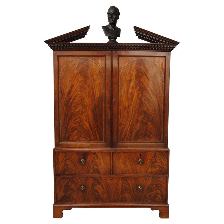 George III mahogany linen press with broken arch pediment, ca. 1770, offered by Hansord