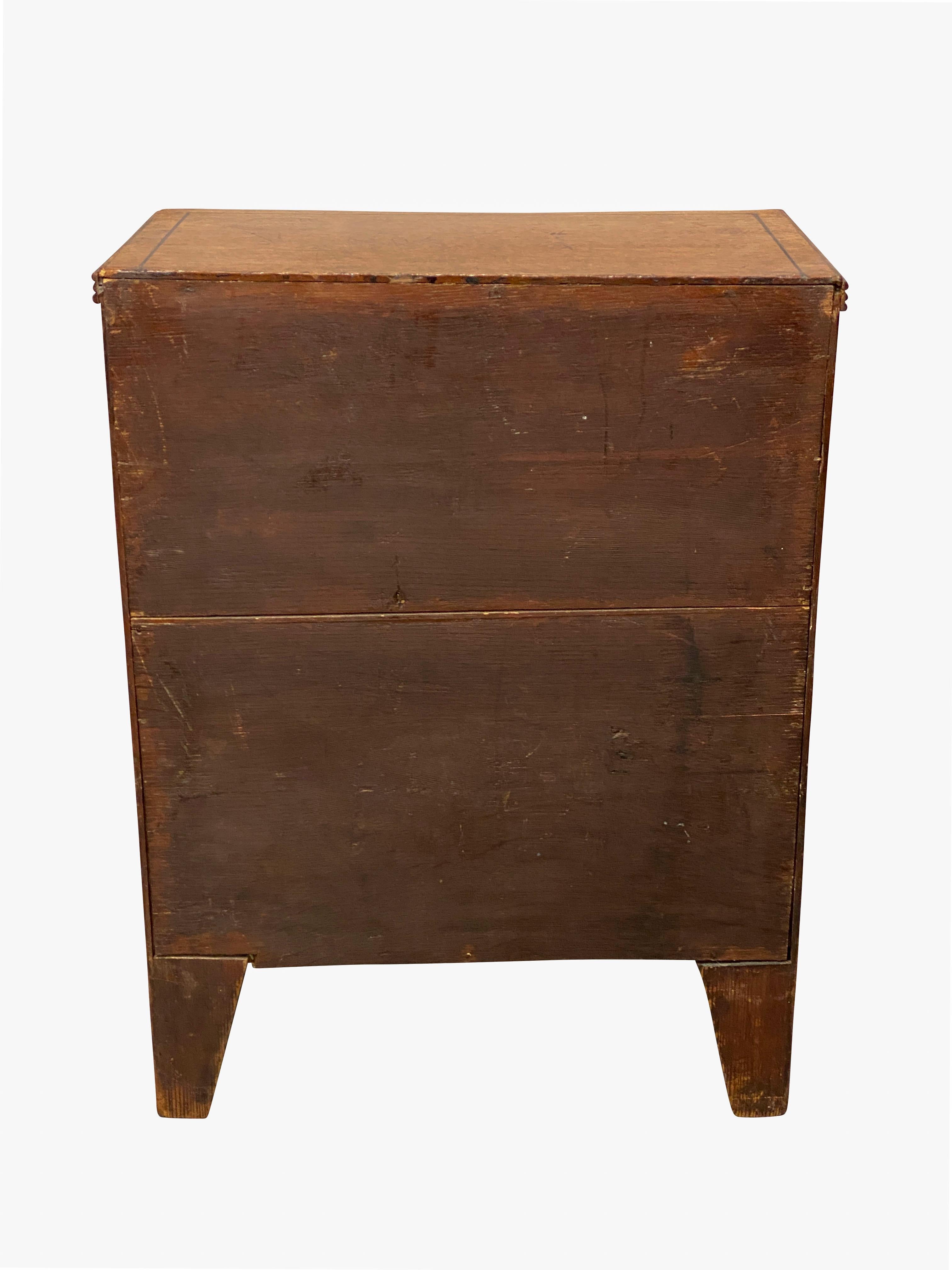 Salesman size with rectangular top over two over three drawers, splayed bracket feet.