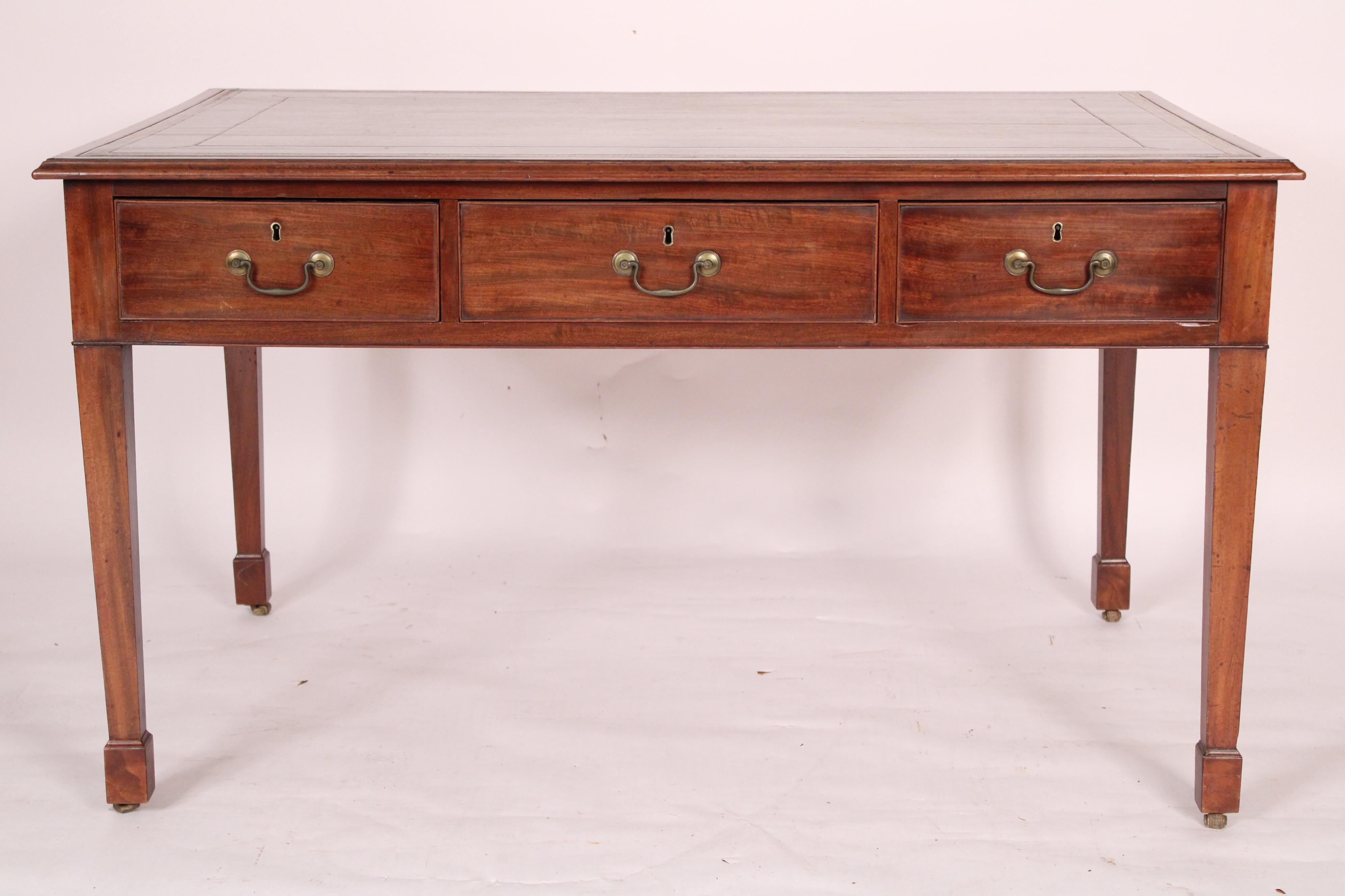 Antique George II style mahogany partners writing table, 19th century. With an inset tooled leather top, mahogany border and molded front, back and side edges, 3 frieze drawers on each side with cock beaded moldings and brass hardware, resting on