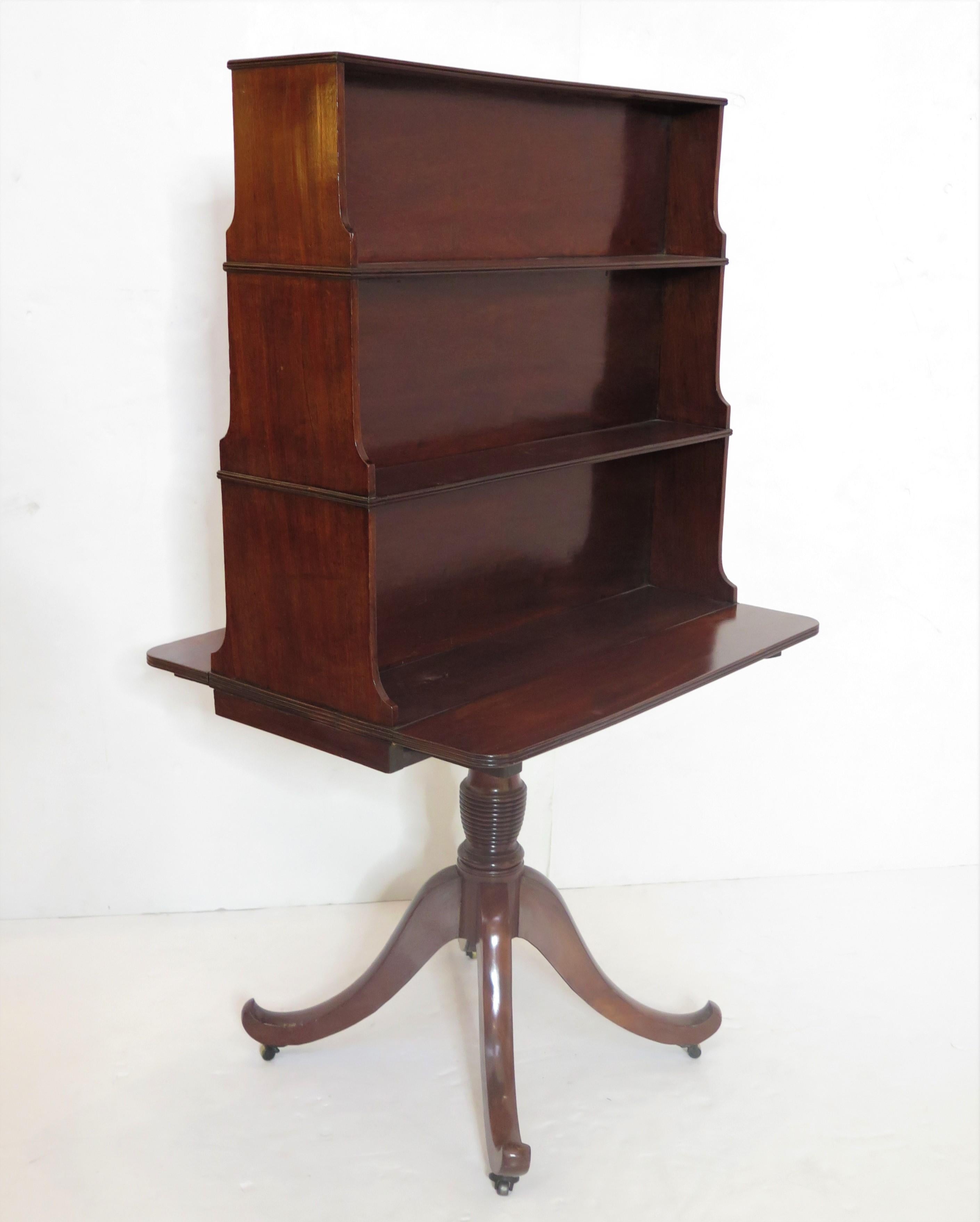 a late 18th century George III freestanding mahogany pedestal waterfall bookcase, unusual form, with small drop leaves, the case consists of three (3) graduating storage compartments on each side, six (6) total, and rests atop a turned column with