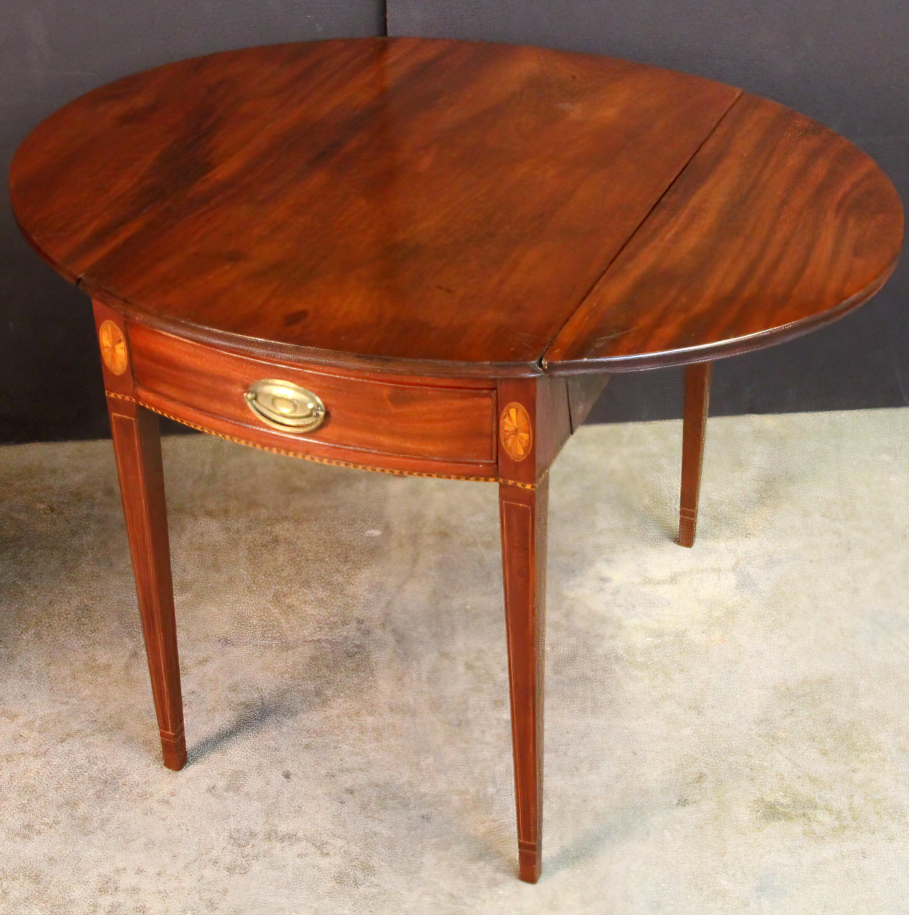 George III mahogany oval top fan inlaid bow front Pembroke table with square tapered legs and singe drawer.