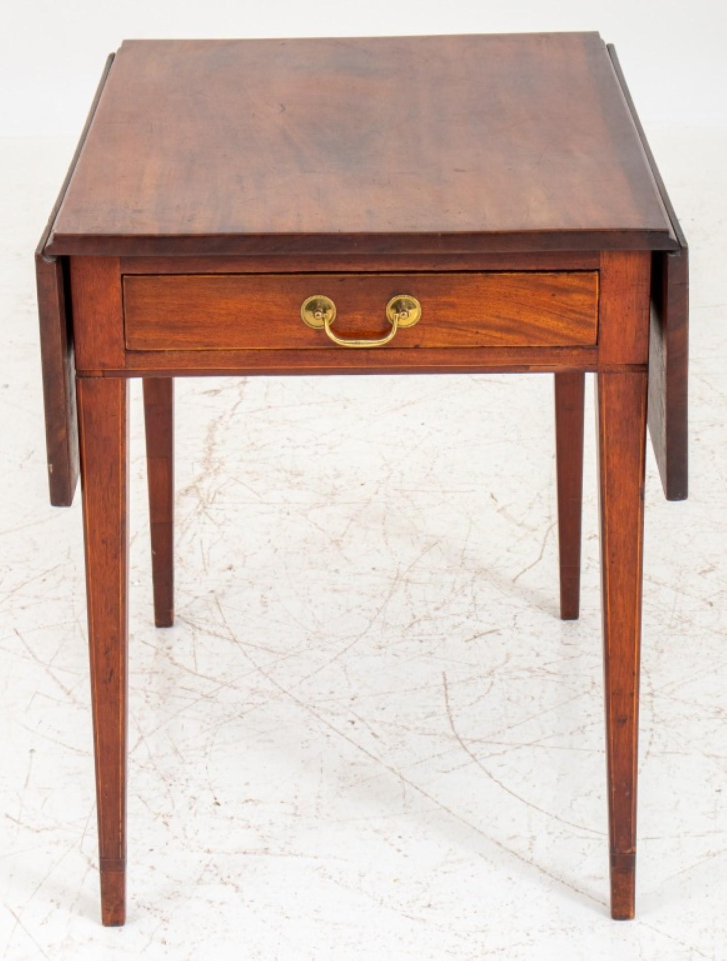 George III Mahogany Pembroke Table, rectangular with two drop sides and a short drawer at one end, the legs with satinwood stringing.

28.5 inches in height, 23 inches in width (41 inches when the drop sides are up), and 30.5 inches in depth.
