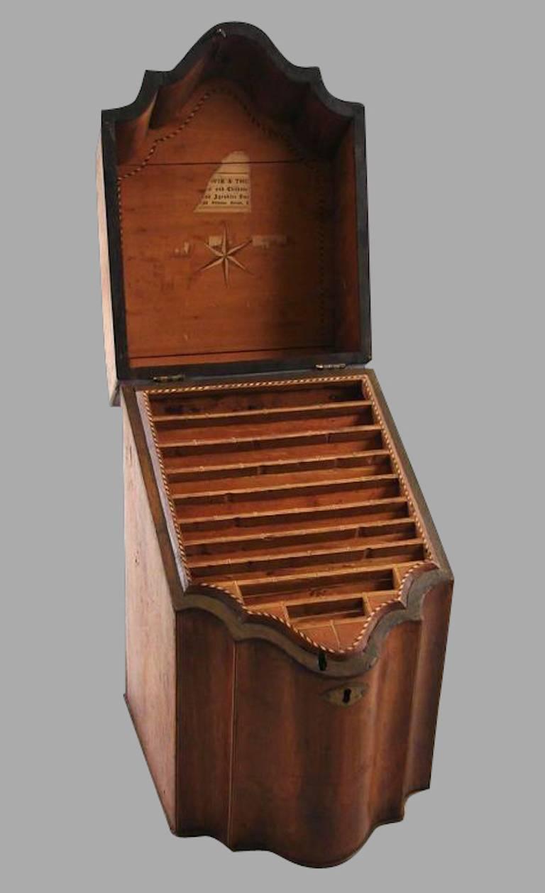 George III satinwood inlaid serpentine knife box, the sloped lid with a central inlaid paterae, the interior now modified to accommodate letters or stationery, circa 1800.