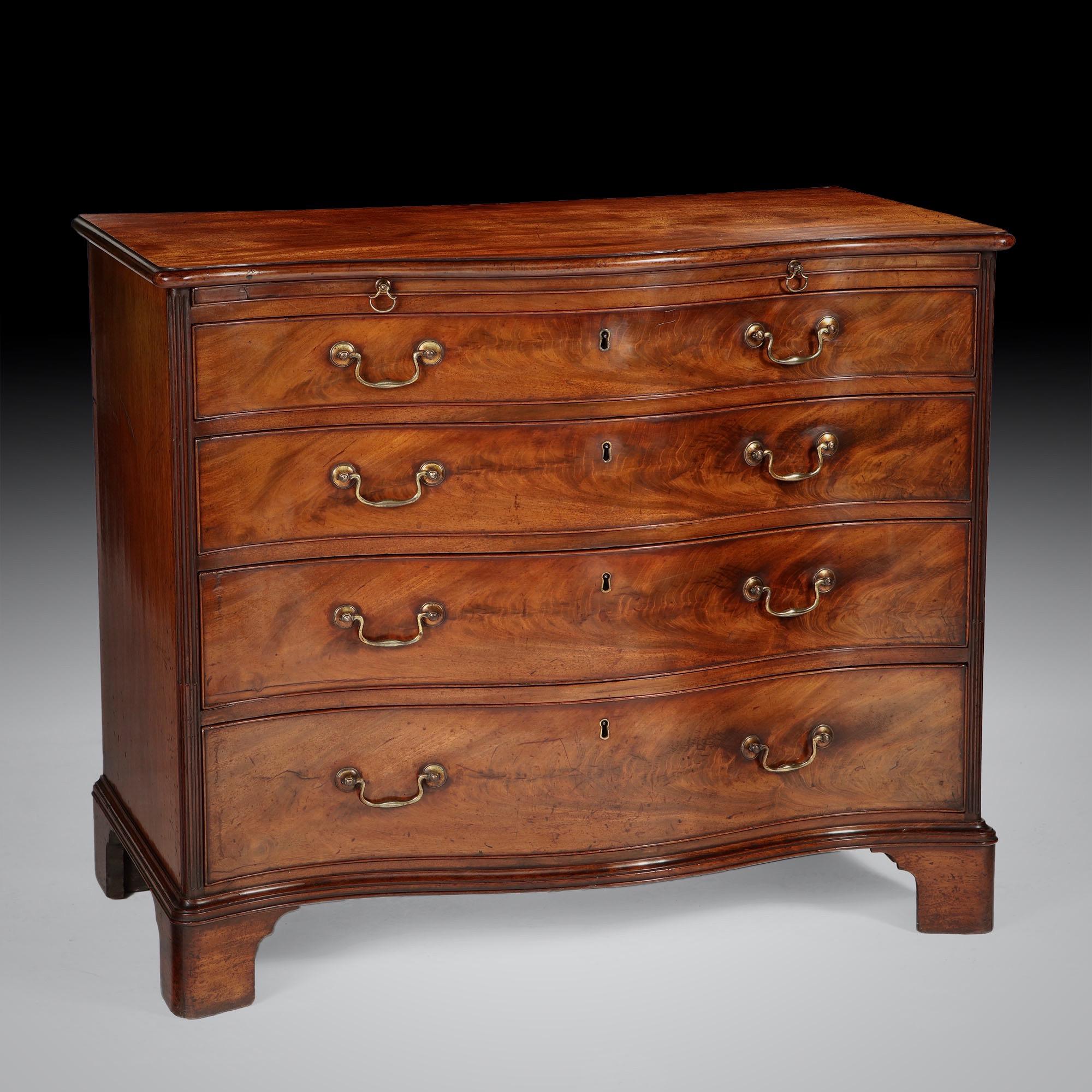 Georgian perfection, 18th century George III mahogany serpentine chest of drawers with brushing slide, fabulous reeded columns and retaining superb original age patinated surface. Choice cuts of flame mahogany veneer sit below the brushing-slide to