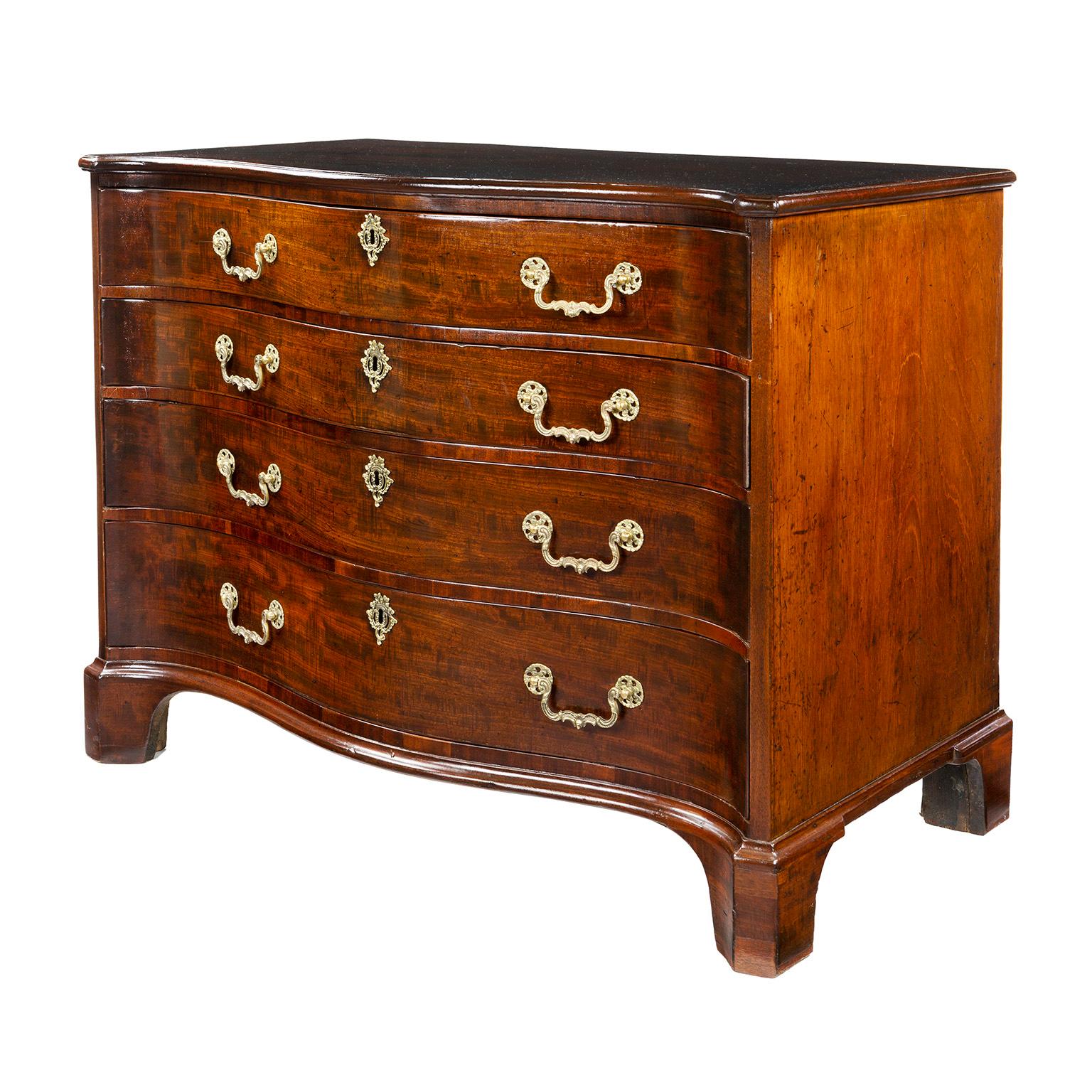 George III mahogany serpentine fronted chest of drawers, circa 1765, comprising four long graduated drawers with cock-beaded edges, the top drawer with a brushing to interior, the drawers retaining Rococo style handles, the whole raised on bracket