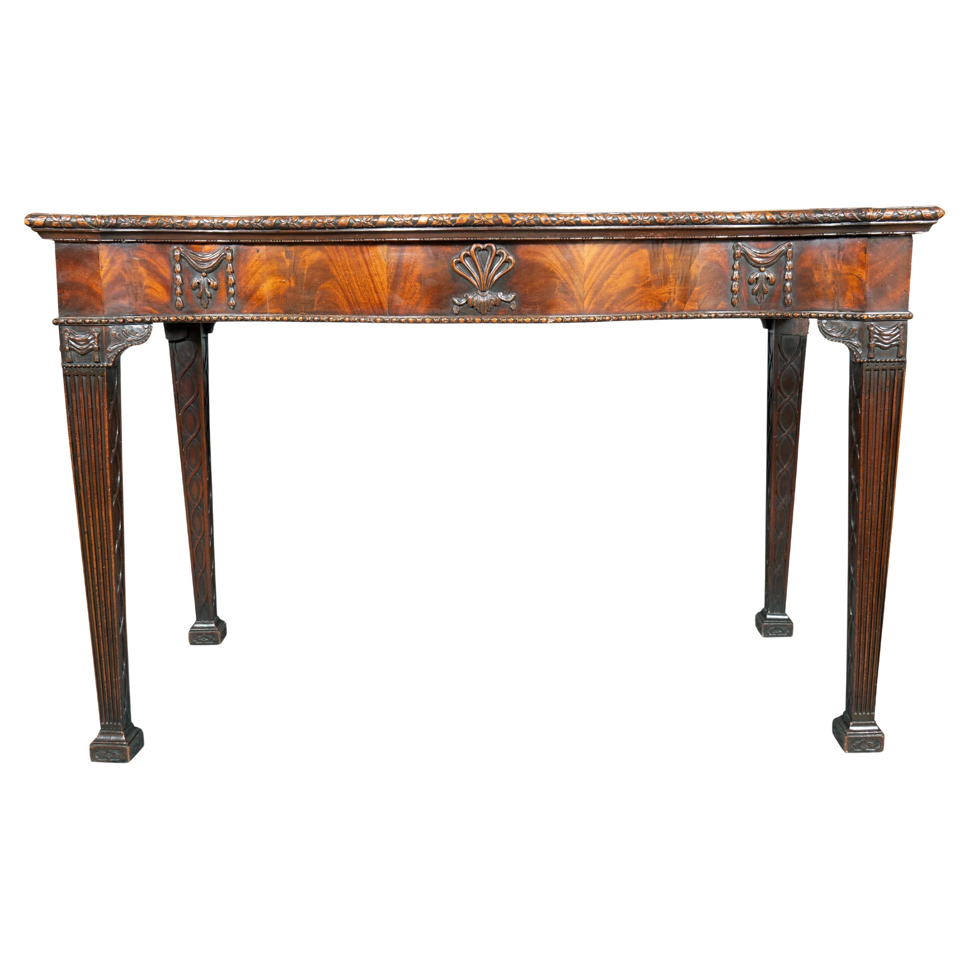 An exceptionally fine Adam period mahogany serving table. Legs are carved on all sides, the carving of the highest quality. Pictured in Connoisseur Magazine , April 1966. With Denys Wrey Ltd , 45 Sloane St London.