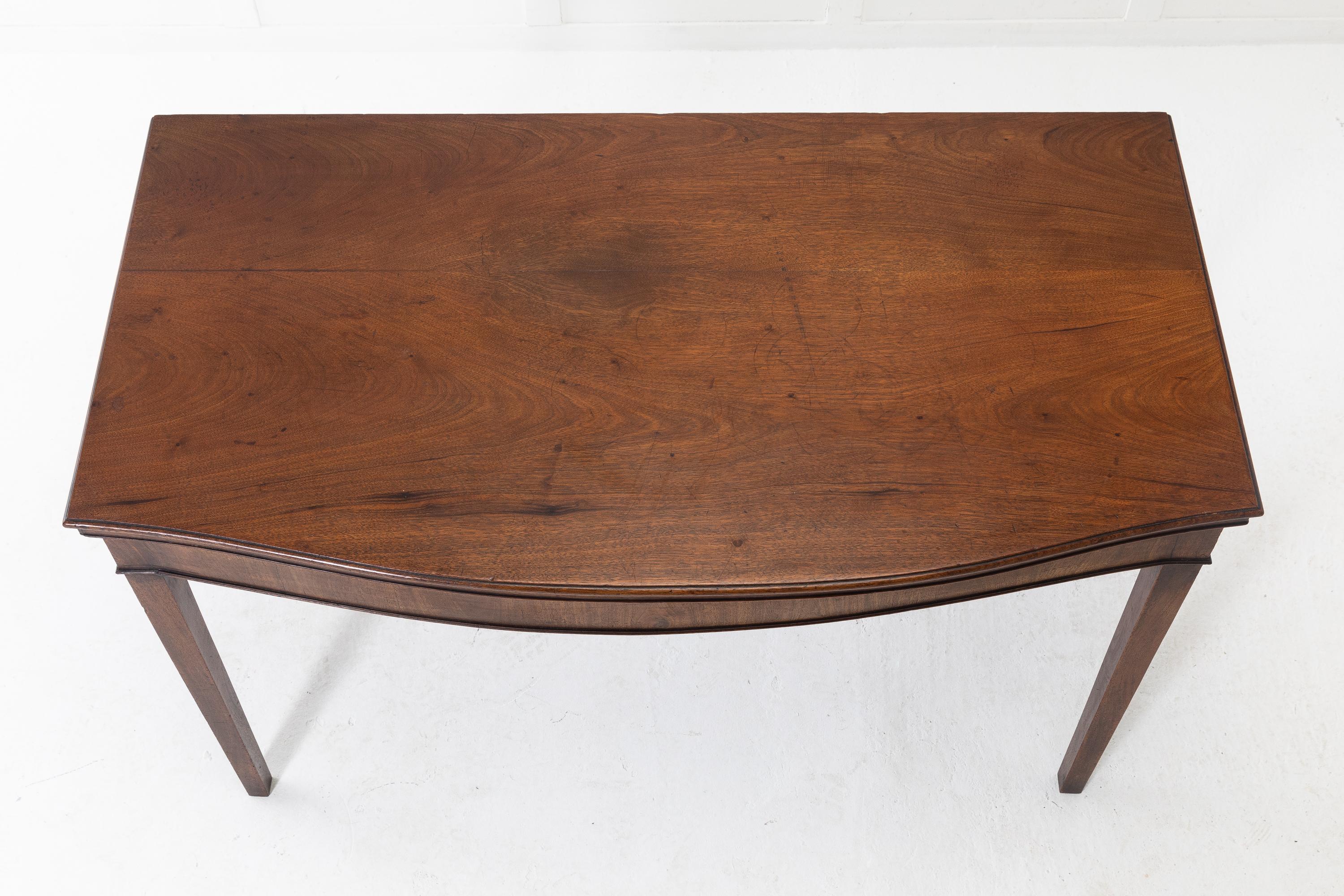 George III mahogany side/serving table, of bow fronted form with a solid mahogany moulded edge top, above a simple frieze. Very good proportions and colour.
    