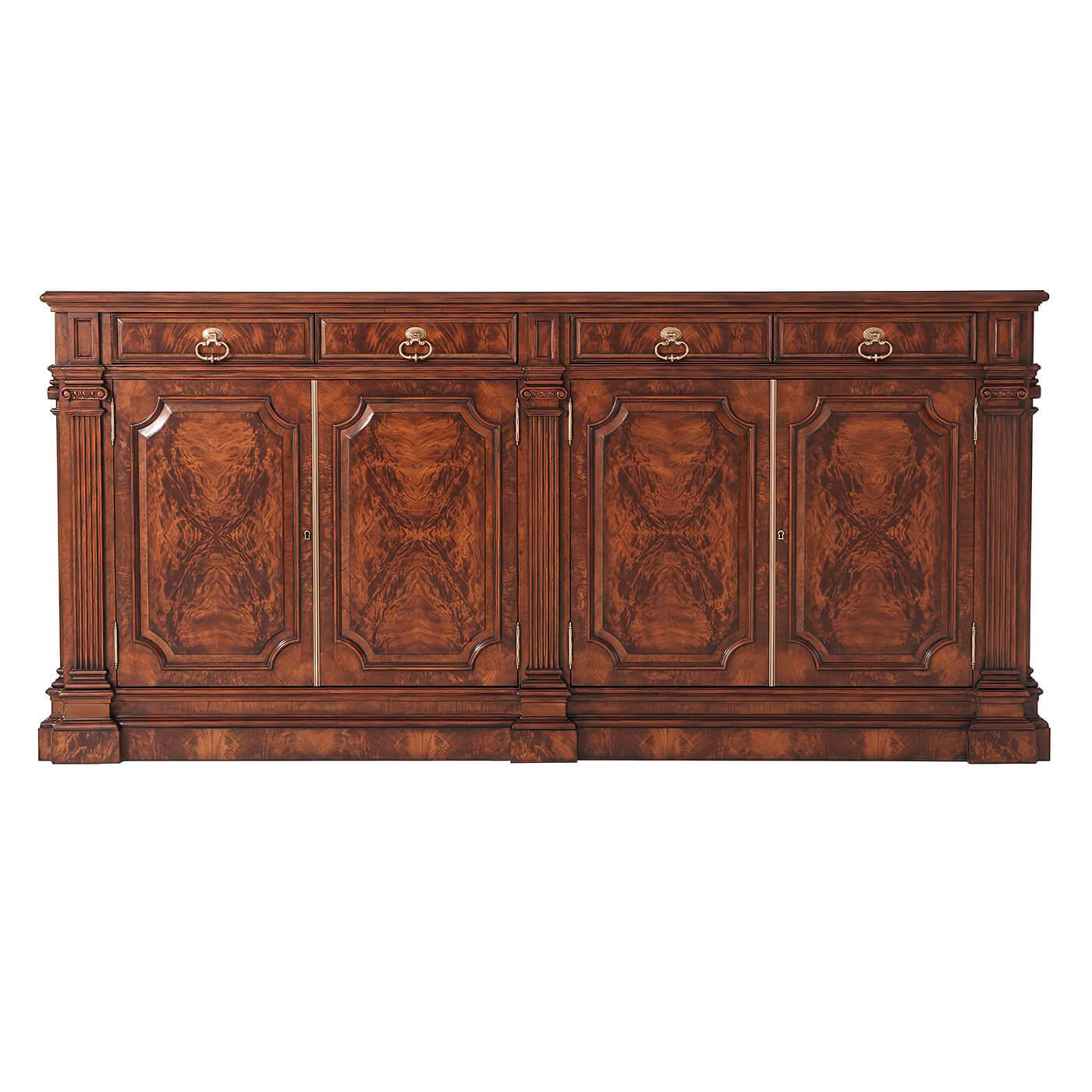 A George III style mahogany and flame veneered sideboard, the rectangular molded edge top above four frieze drawers and four-paneled doors enclosing two adjustable shelves, between fluted column uprights, on a plinth base.

Dimensions: 90.75