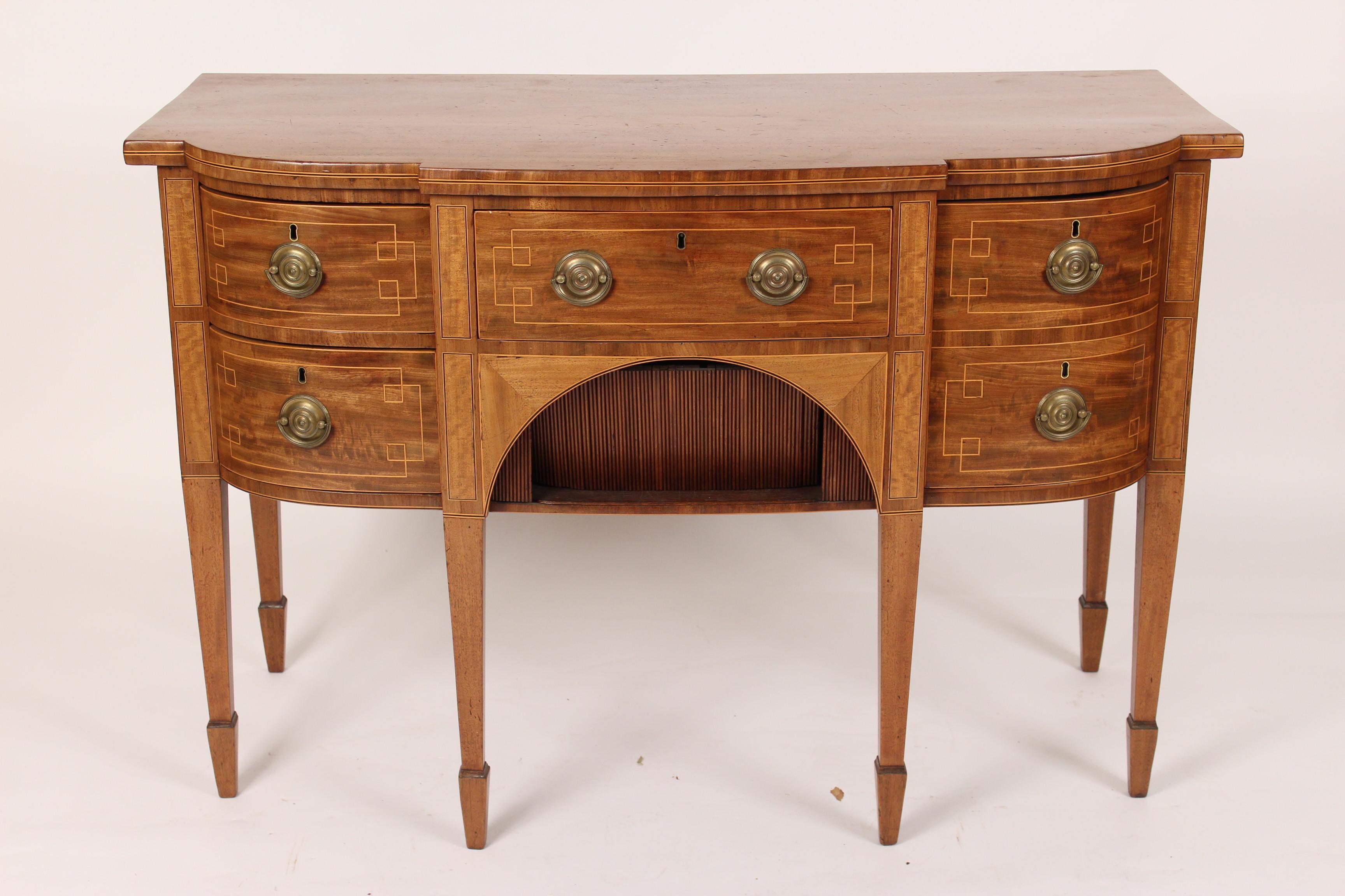 George III mahogany sideboard server, early 19th century. With well figured mahogany drawer fronts , a tambour door beneath the center drawer, string inlay and square tapered legs terminating in spade feet.