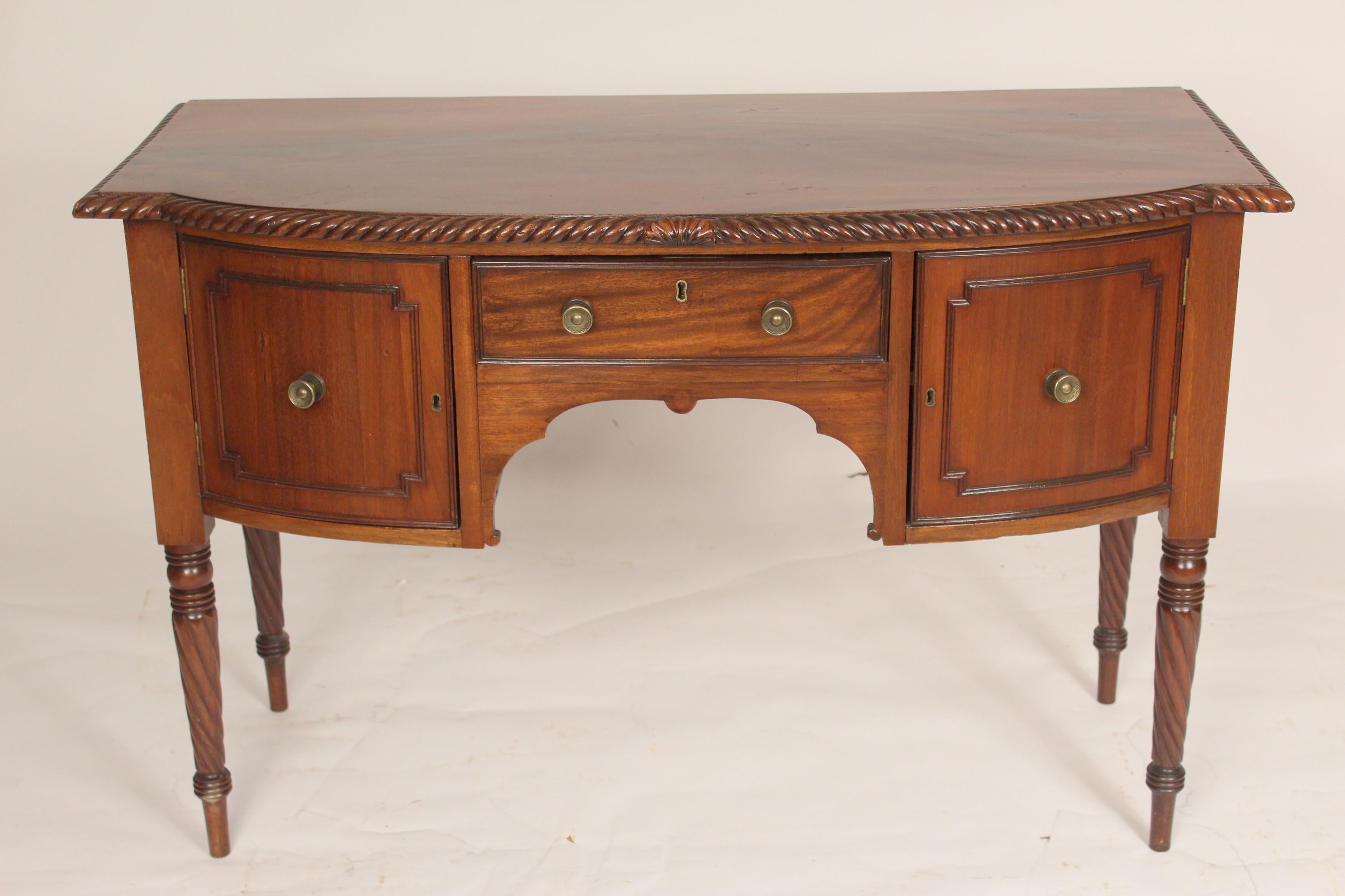 Late George III mahogany small scale sideboard, early 19th century. With a nicely grained mahogany top, a central drawer flanked by two cupboard doors, resting on rope turned legs.