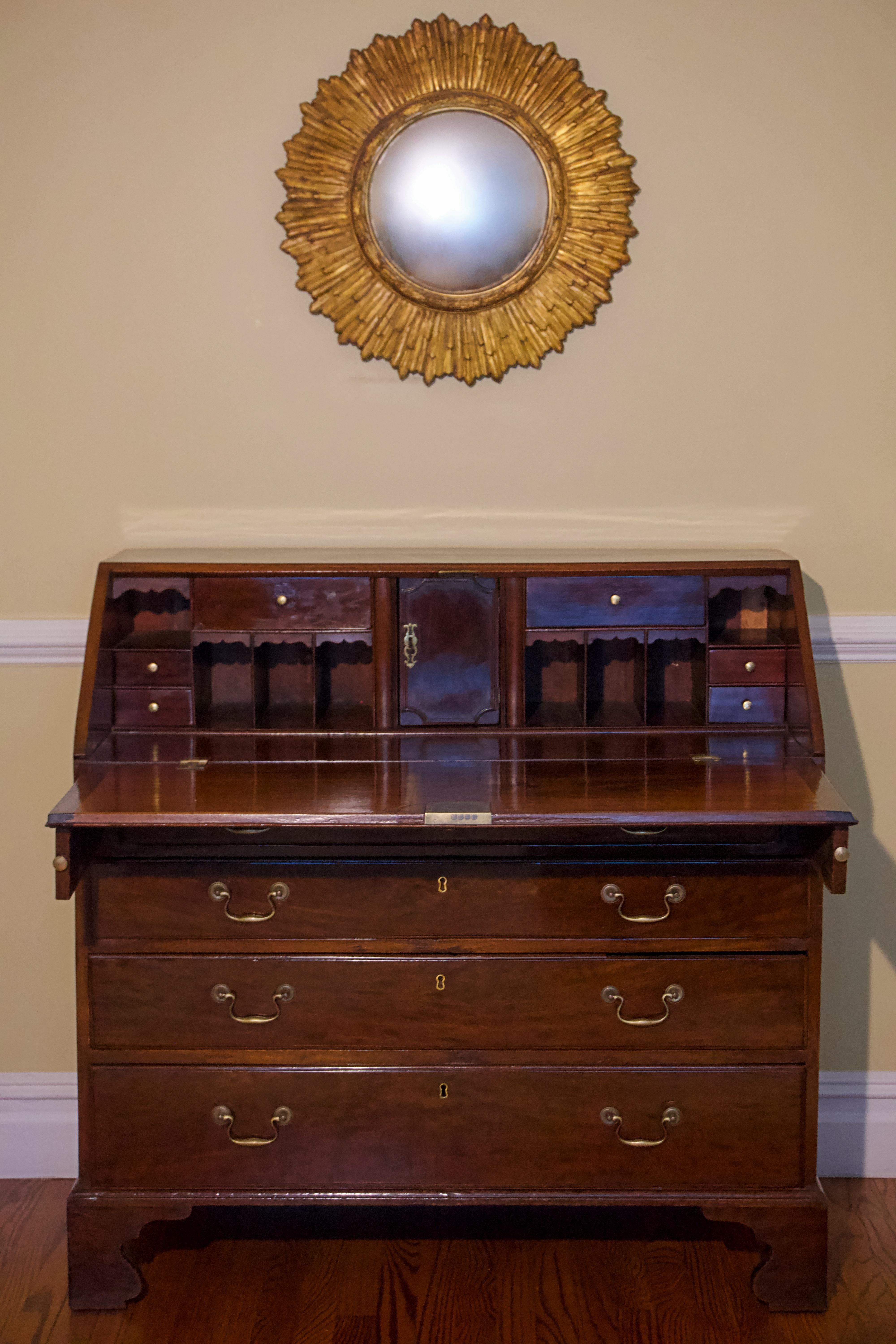 George III mahogany slant-front bureau, English, 18th century with brass accents.