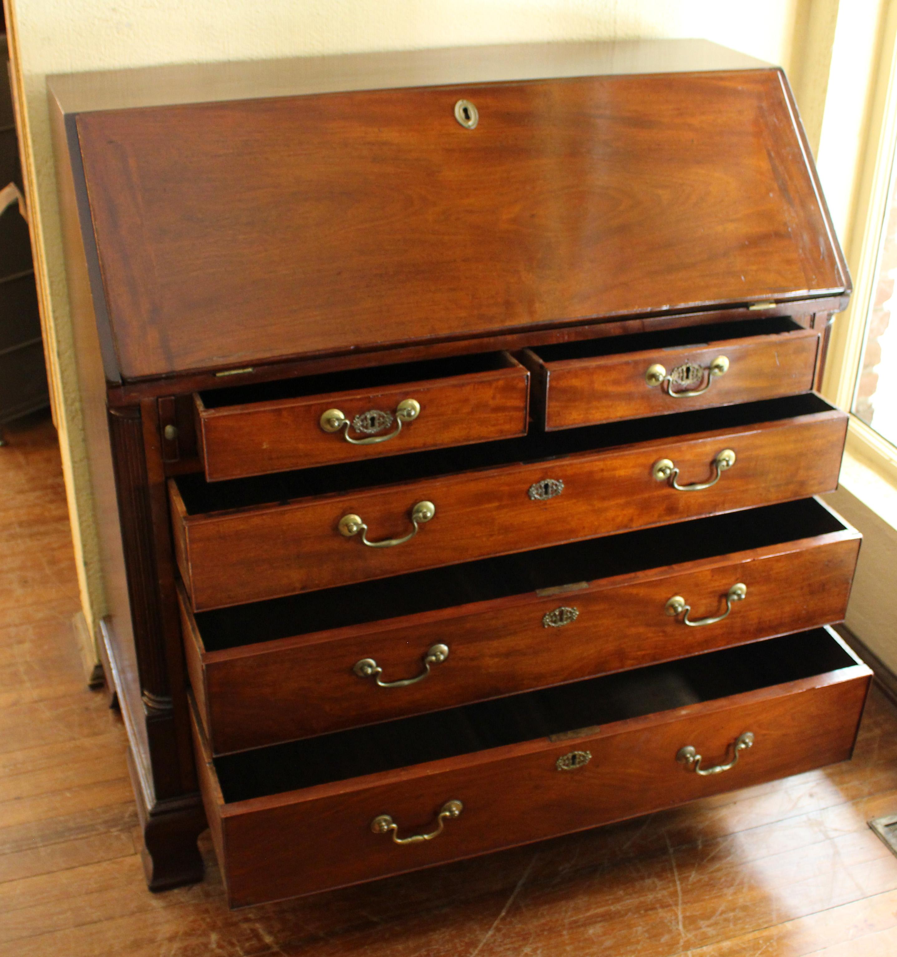 A superb quality George III slant front bureau of rich mahogany timbers with mahogany veneers. Circa 1765-80. Exceptional interior in Chippendale Gothic taste, with shaped, stepped drawers and pigeon holes with paper drawers in valences. Raised on