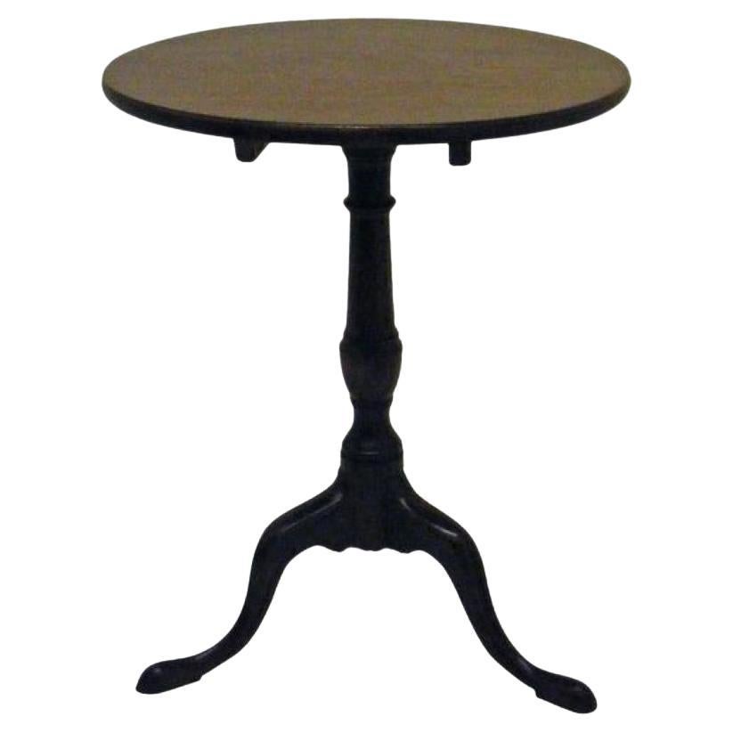 This is a lovely example of a small Georgian tilt-top table in fine untouched original condition. The top, which is made from rich warm grain mahogany with good patina, is mounted on a elegantly shaped column with tripod legs and slipper toes.
This