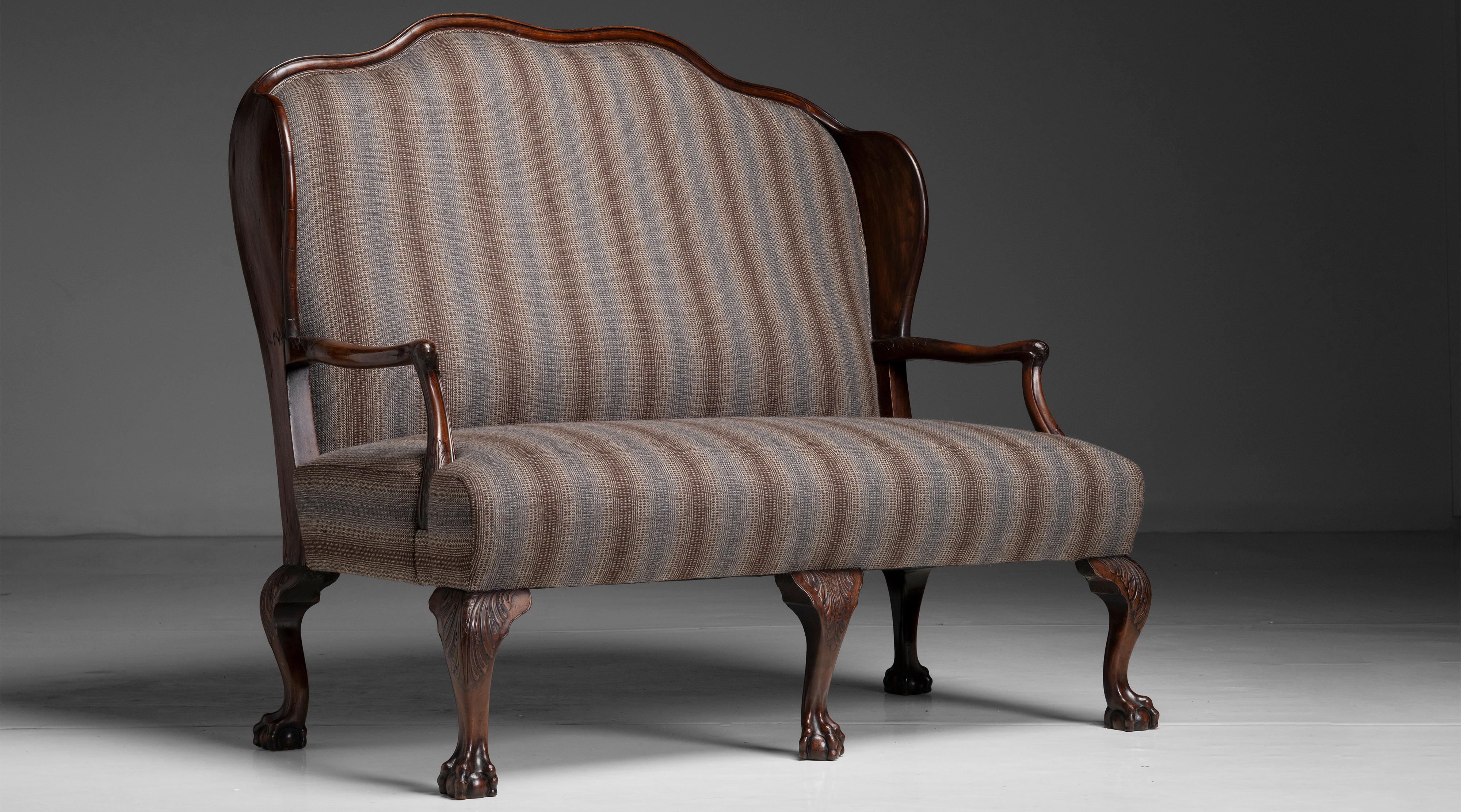 George III Mahogany Sofa
England circa 1750
On carved mahogany frame, with ball and claw feet, newly upholstered in striped wool from Maharam.
57”w x 27”d x 52”h x 18”seat
