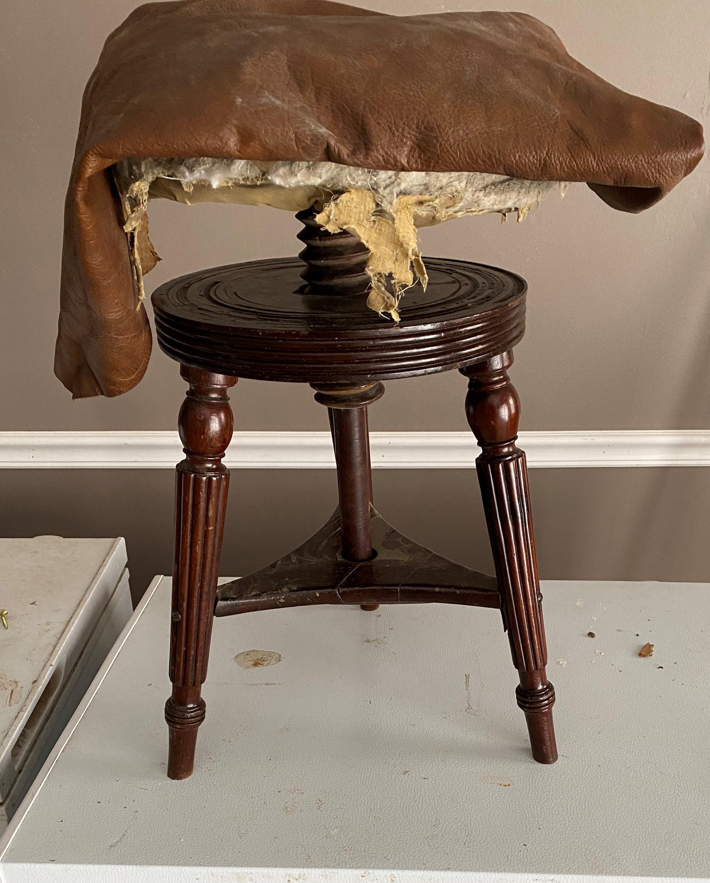 Adjustable piano stool, I wanted to cover it in leather and use brass studs' for a Fine finished look and never took the time. You can do it. Height is adjustable. I throw in the leather unless you don't want it. Reeded leg.  This is a choice